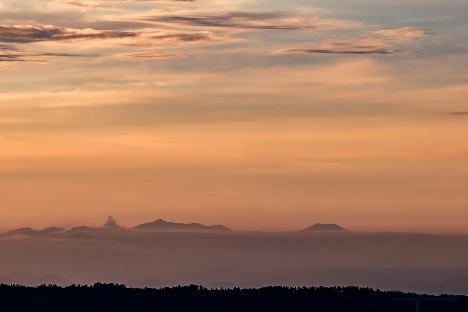 Beautiful sunset sky with silhouettes of distant islands