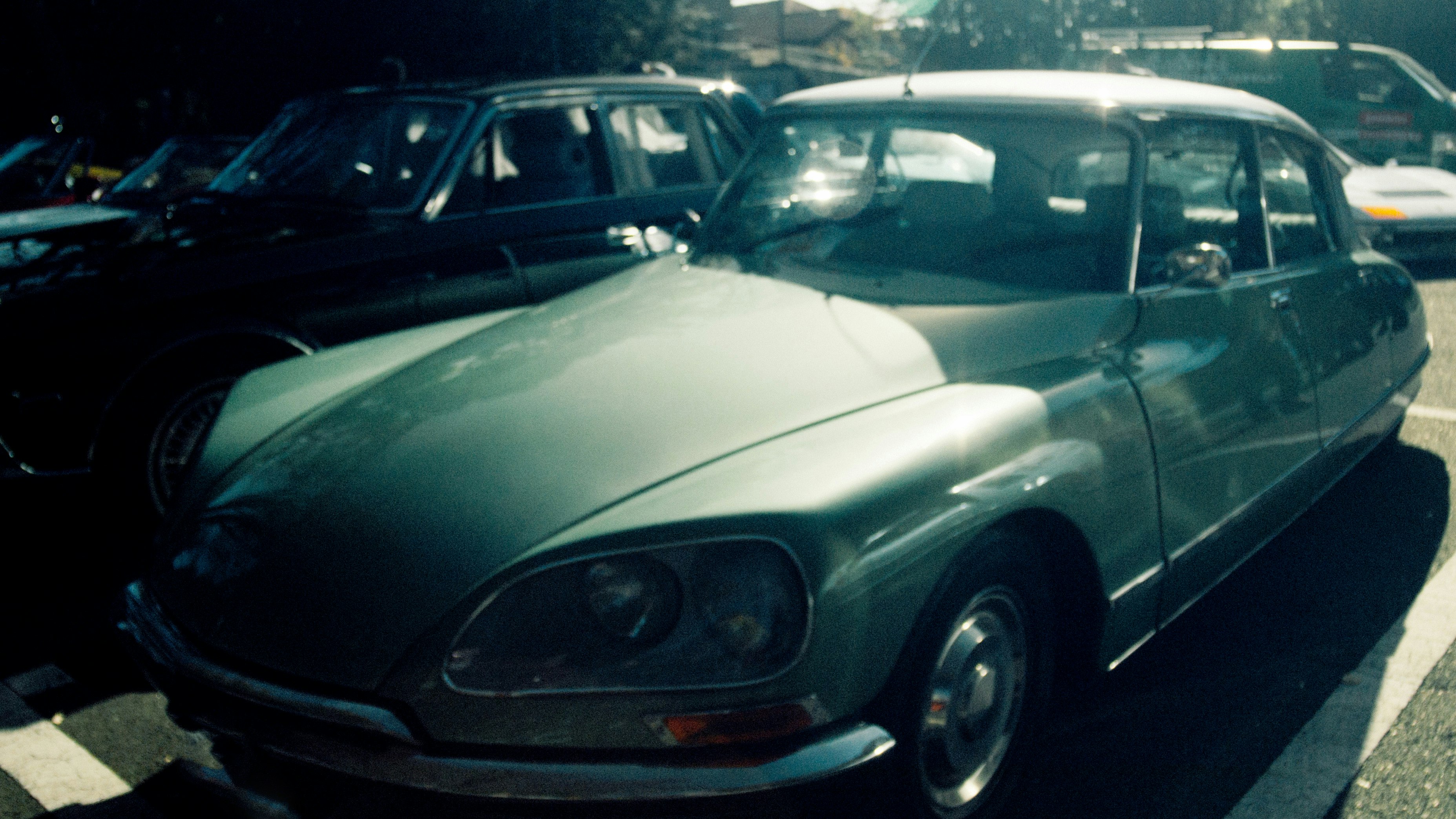 classic cars lined up in a parking lot