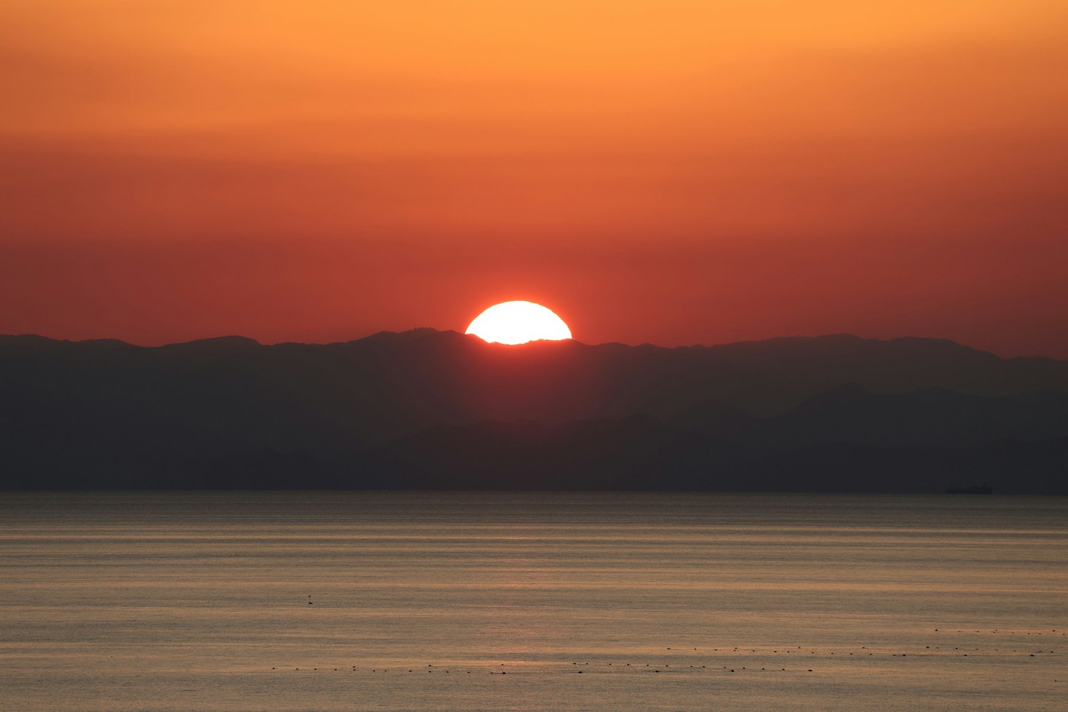 Hermoso atardecer sobre montañas con tonos naranjas y rojos