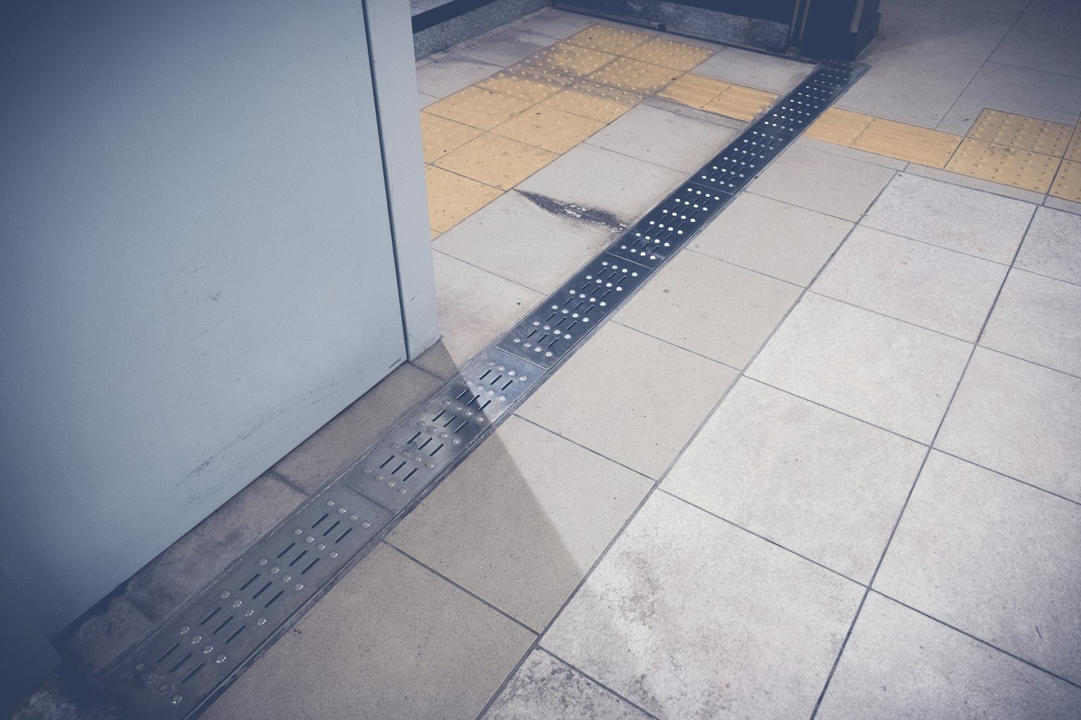 Photo of tiled entrance with drainage channel