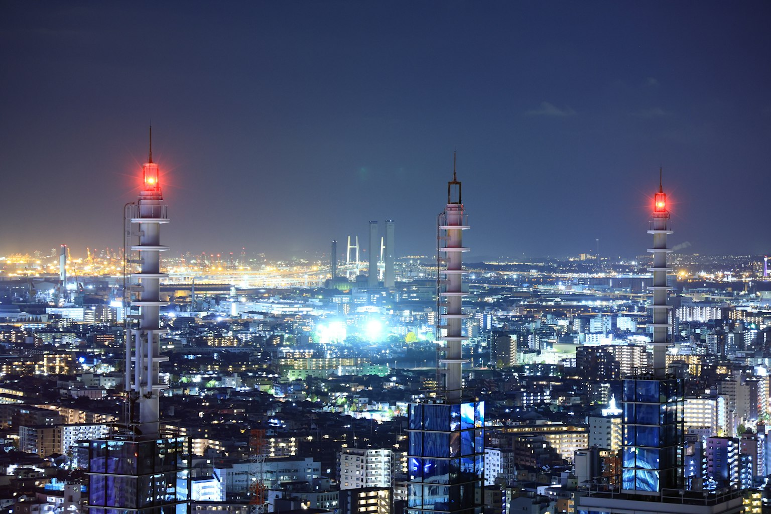 Vista notturna dello skyline di Tokyo con torri radio e luci rosse