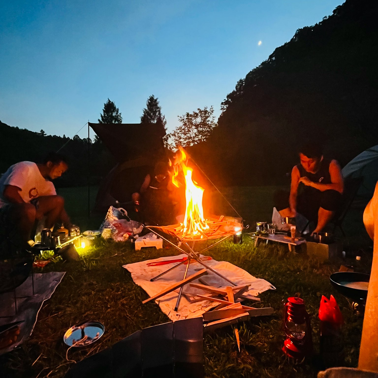 People gathered around a campfire in a natural setting