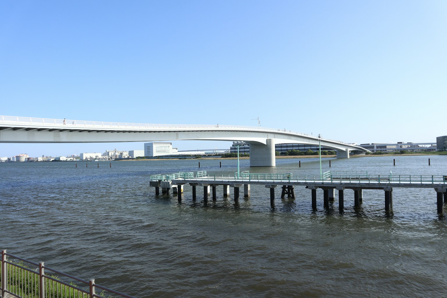 White bridge spanning over a river with rippling water