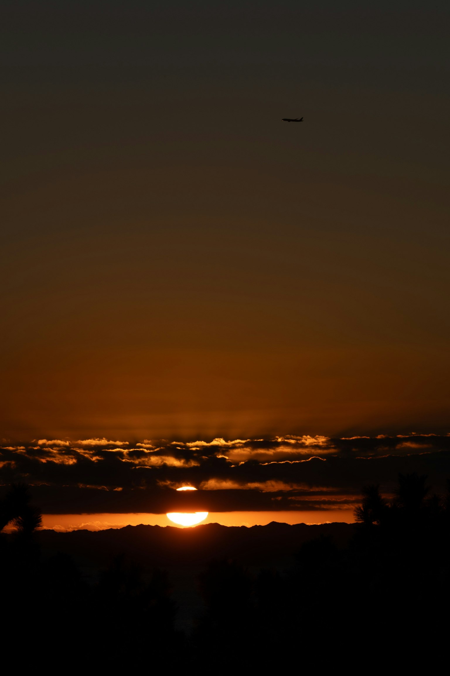 A beautiful sunset over clouds with an orange sky