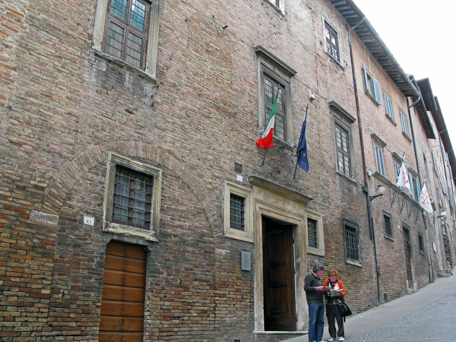 Old brick building with two people standing outside