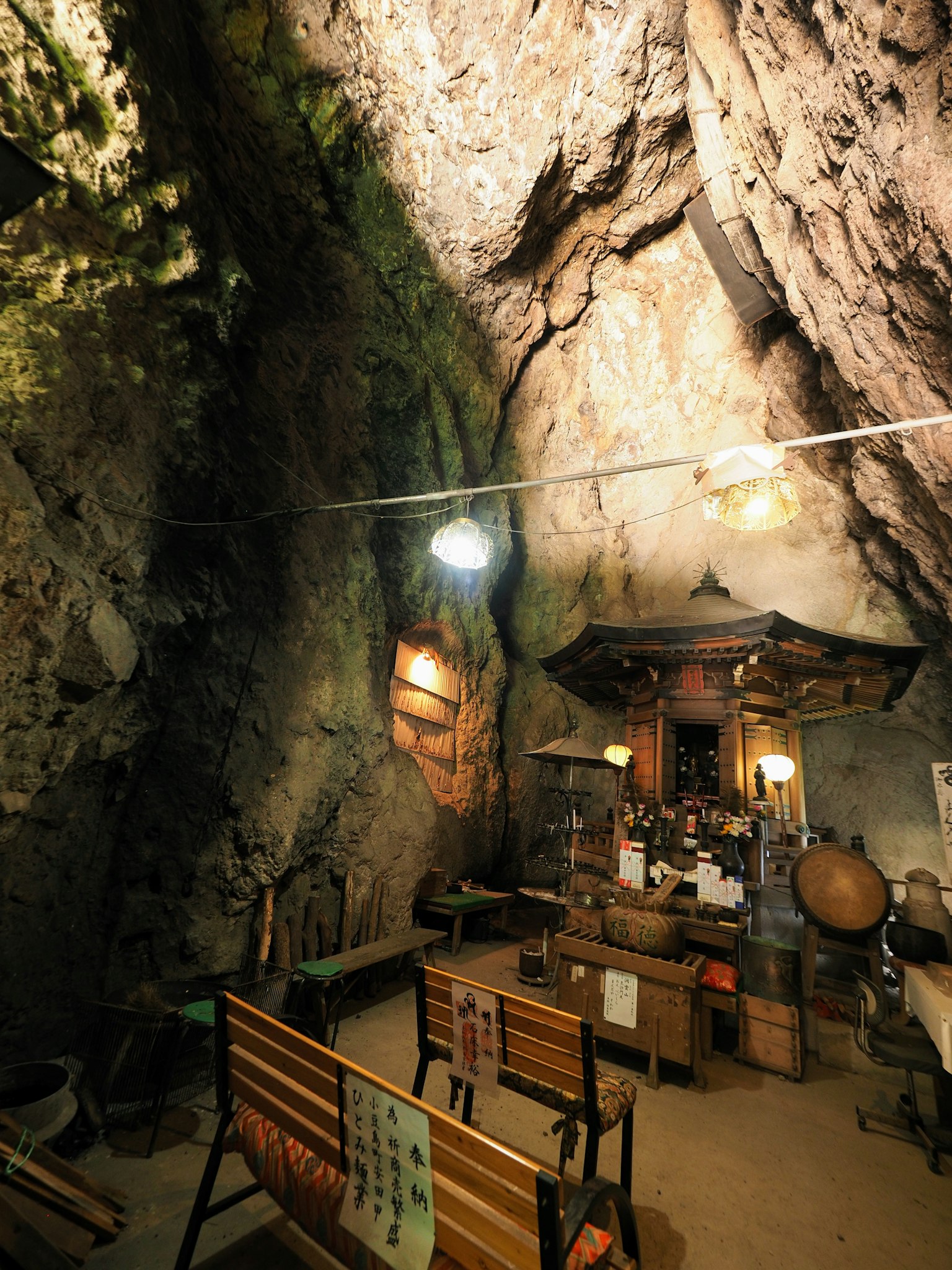 Interior of a cave with benches and a small altar