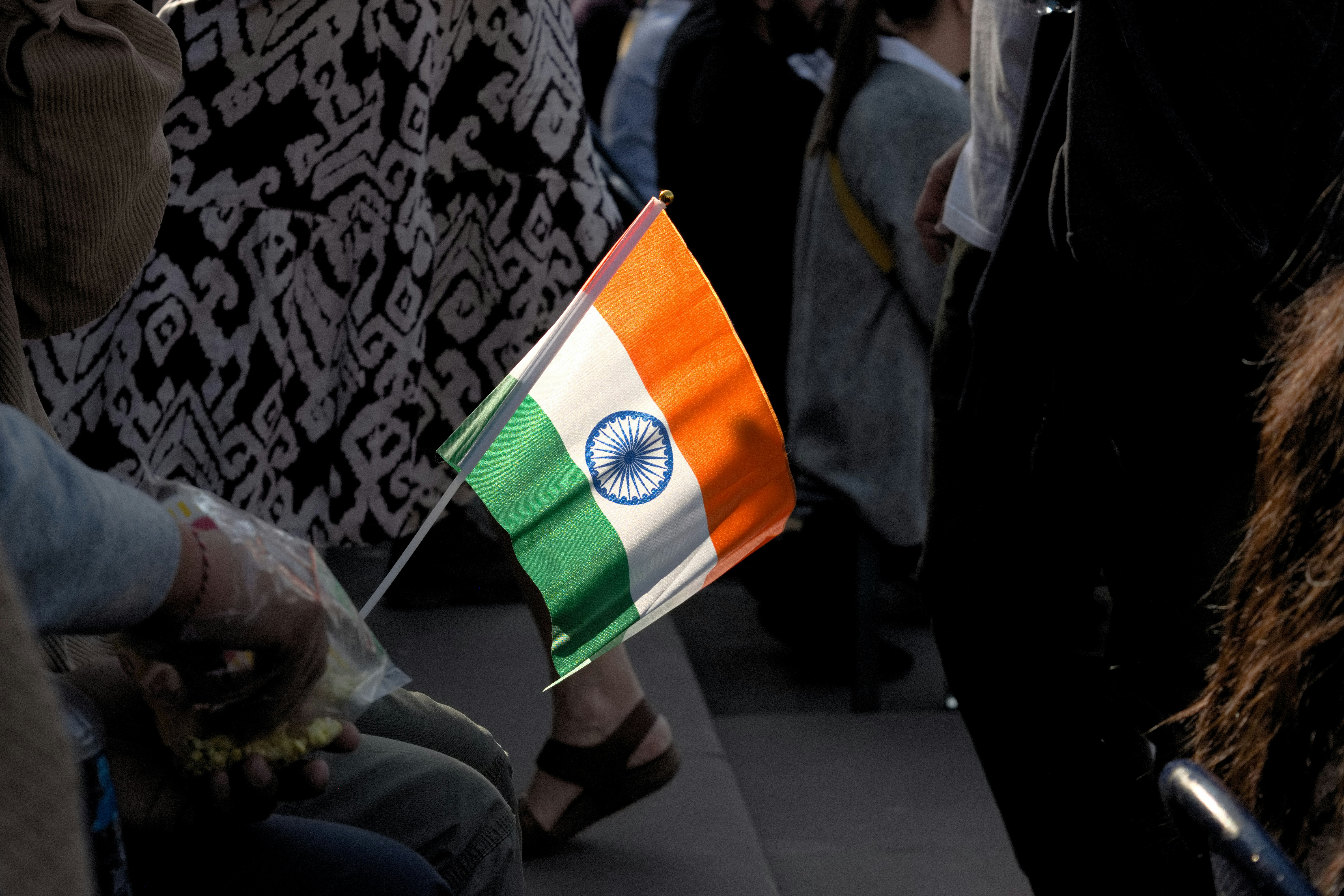 People holding an Indian flag at a gathering