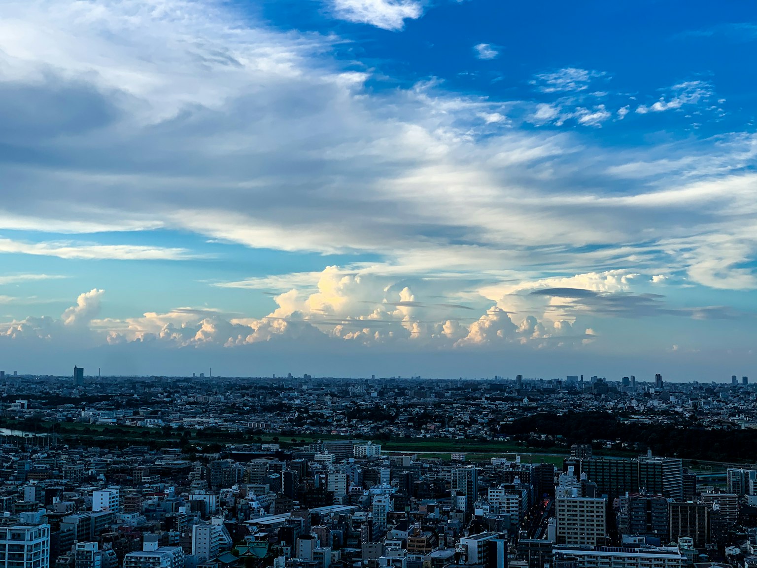 Cityscape of Tokyo with blue sky and scattered clouds