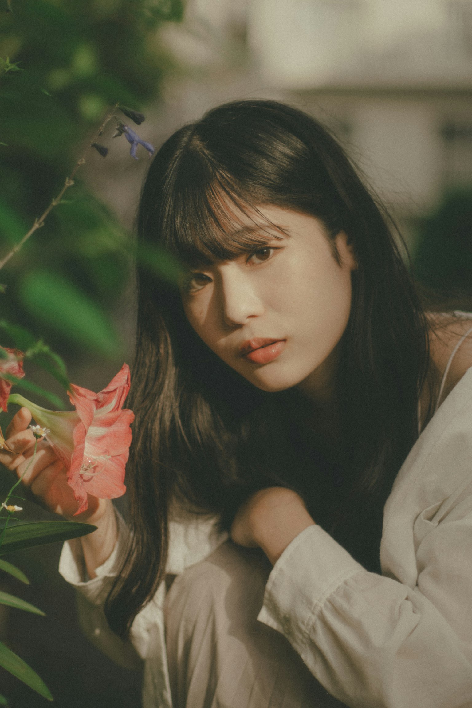 在绿色背景下手持花卉的女性肖像