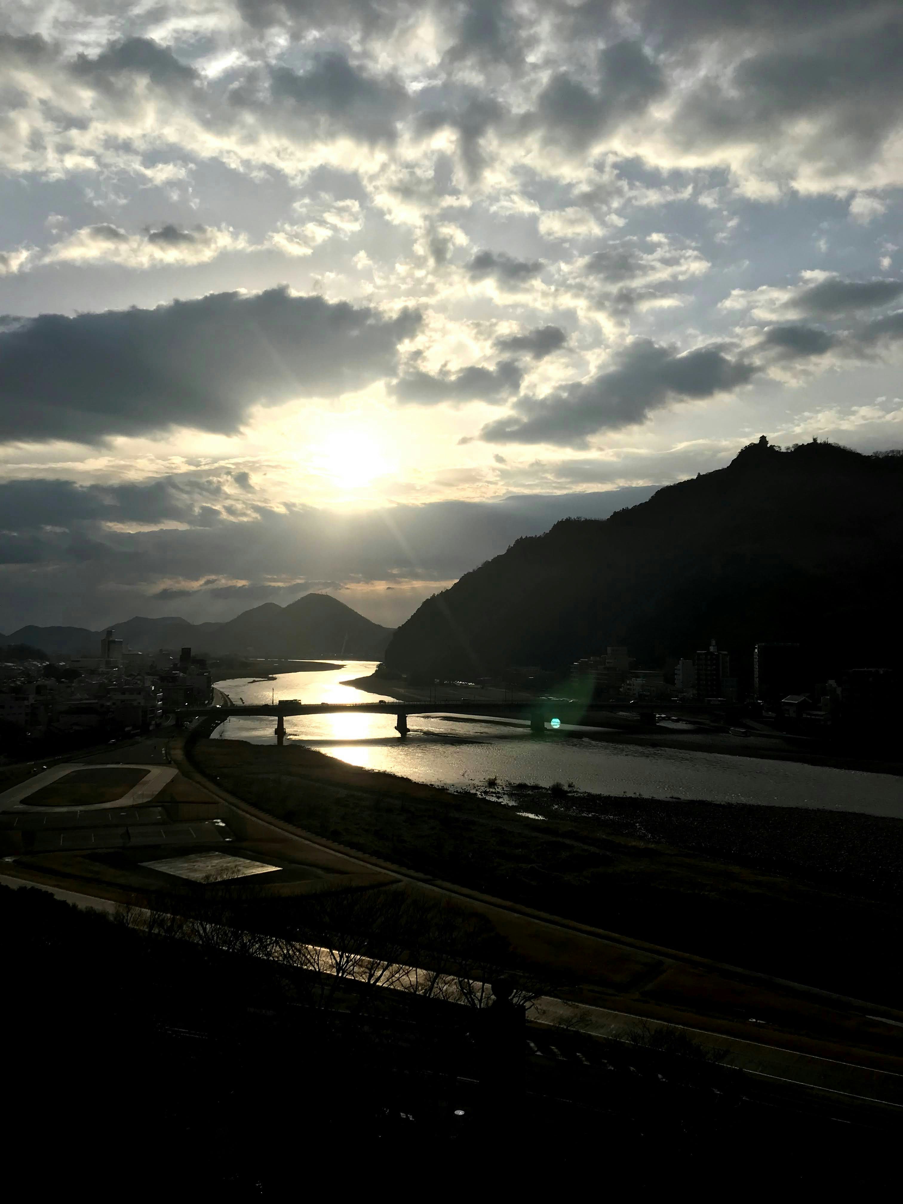 dusk view over a coastal bay and mountain silhouettes