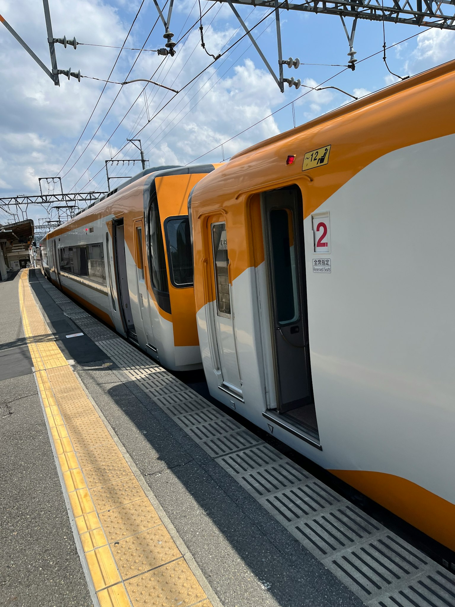Orange and white train at the station