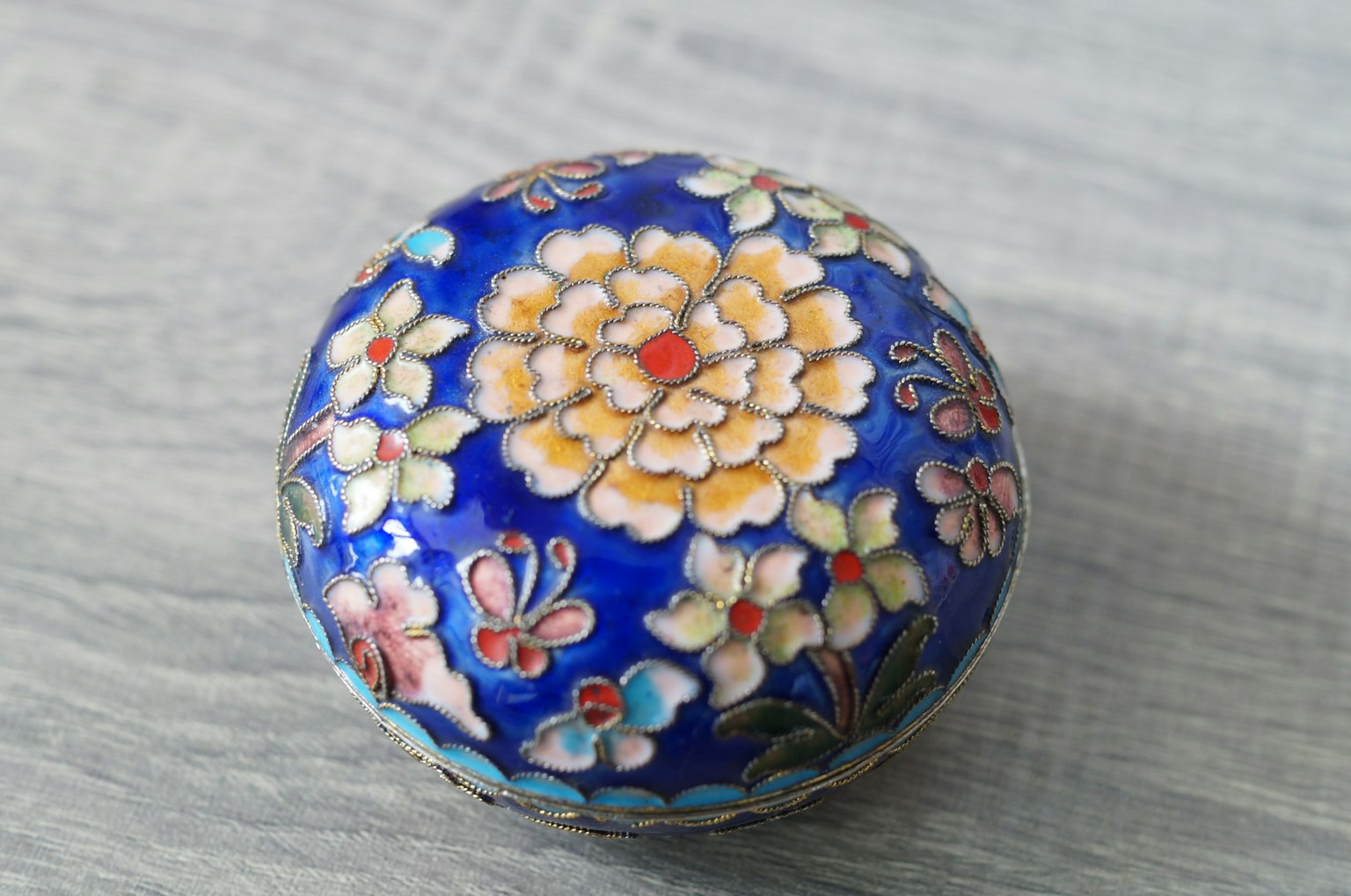 Round decorative item with floral patterns on a blue background