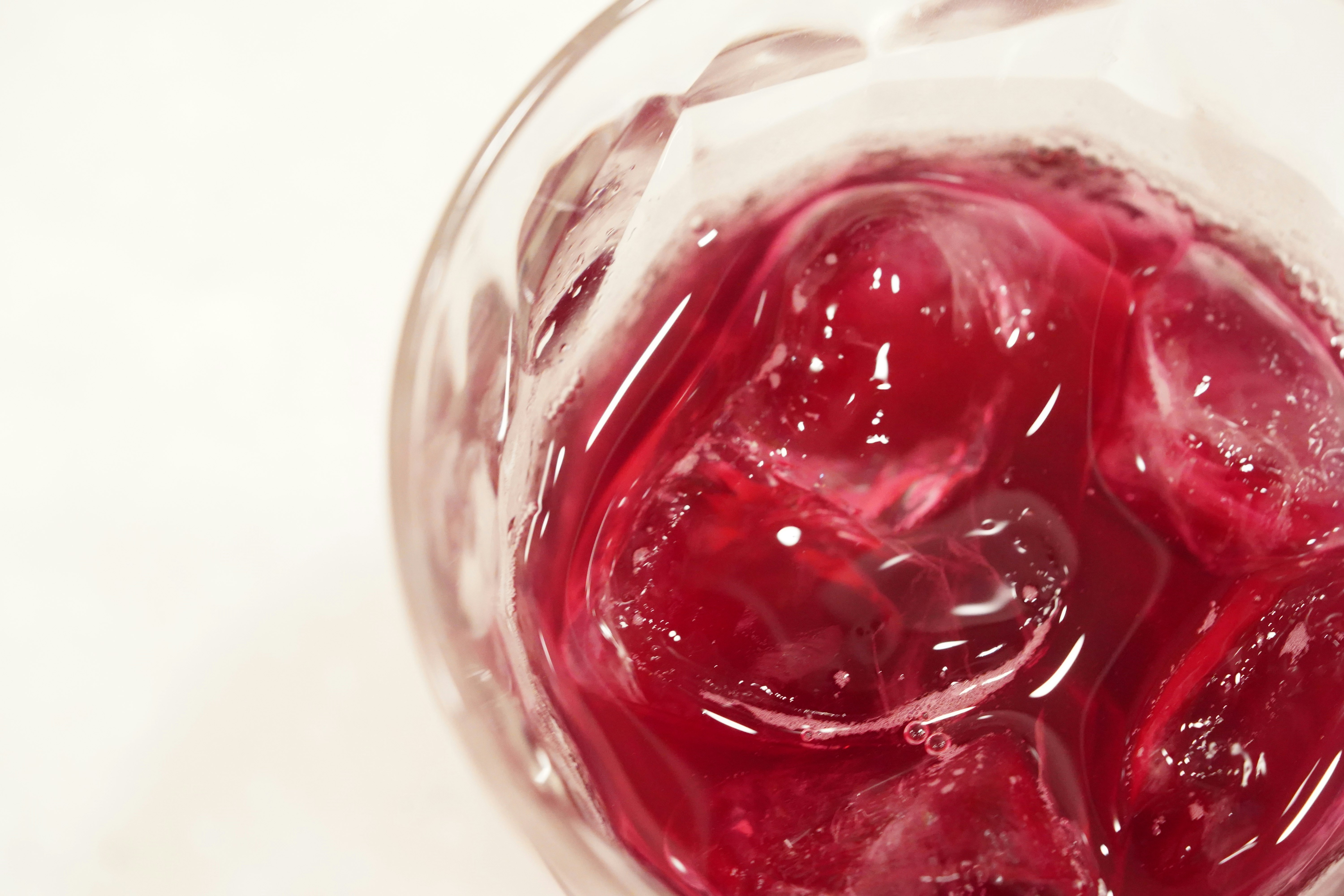 close-up of a transparent glass container filled with red liquid