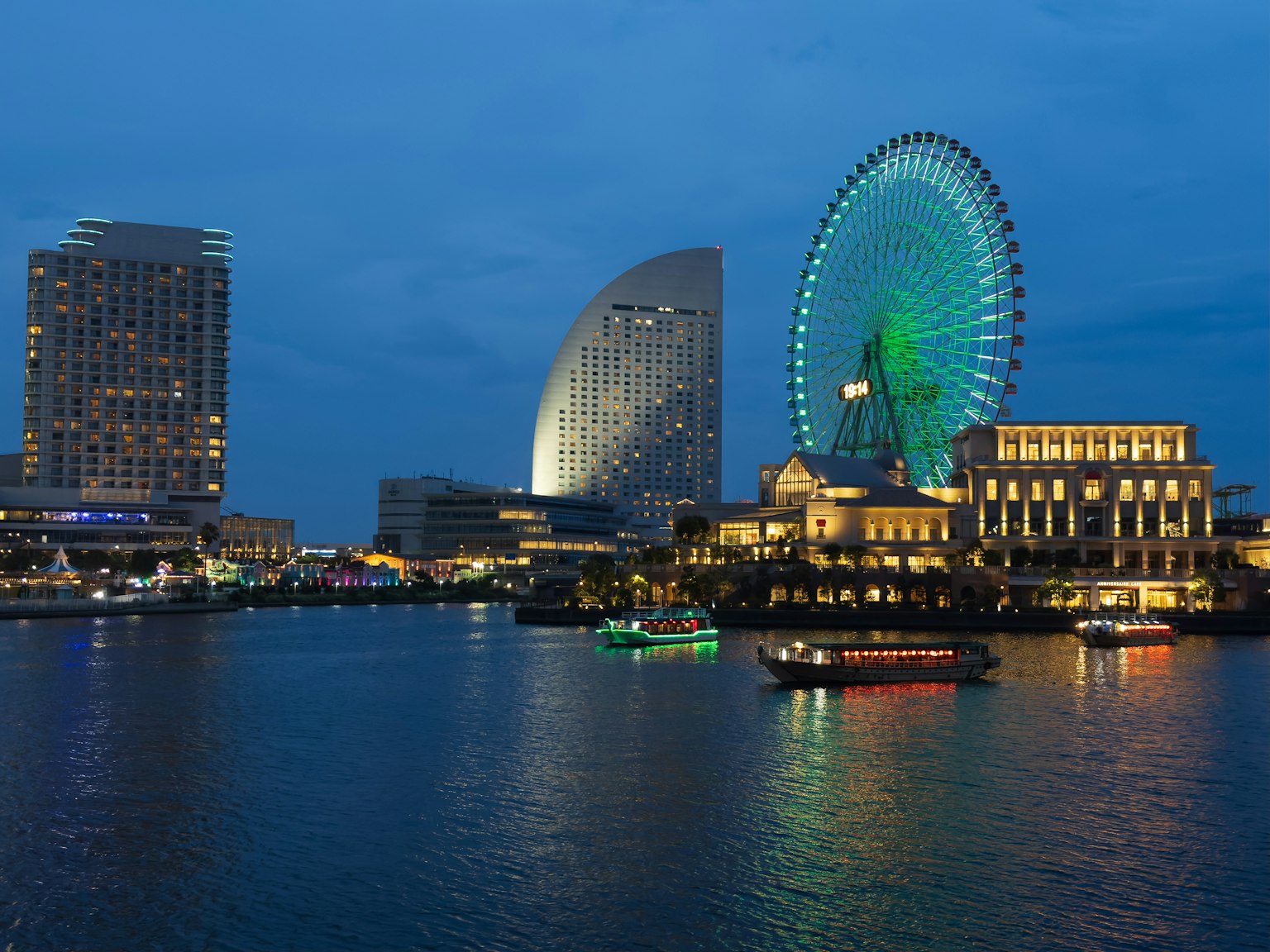 Night view of Yokohama featuring a Ferris wheel and skyscrapers