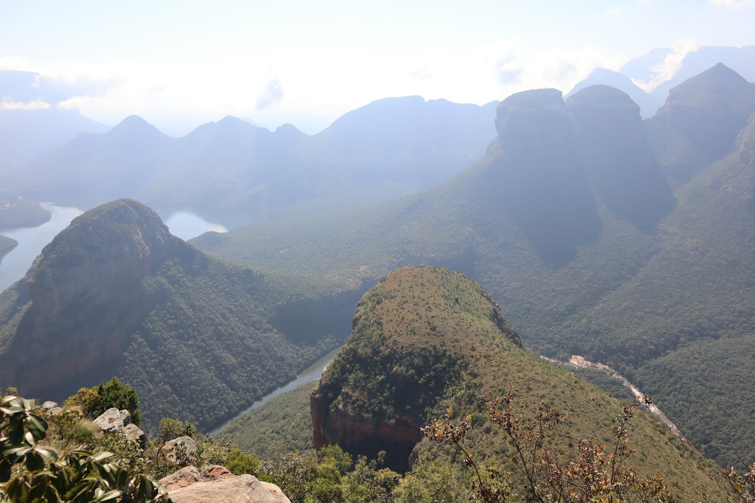 Scenic view of mountains and river with lush greenery