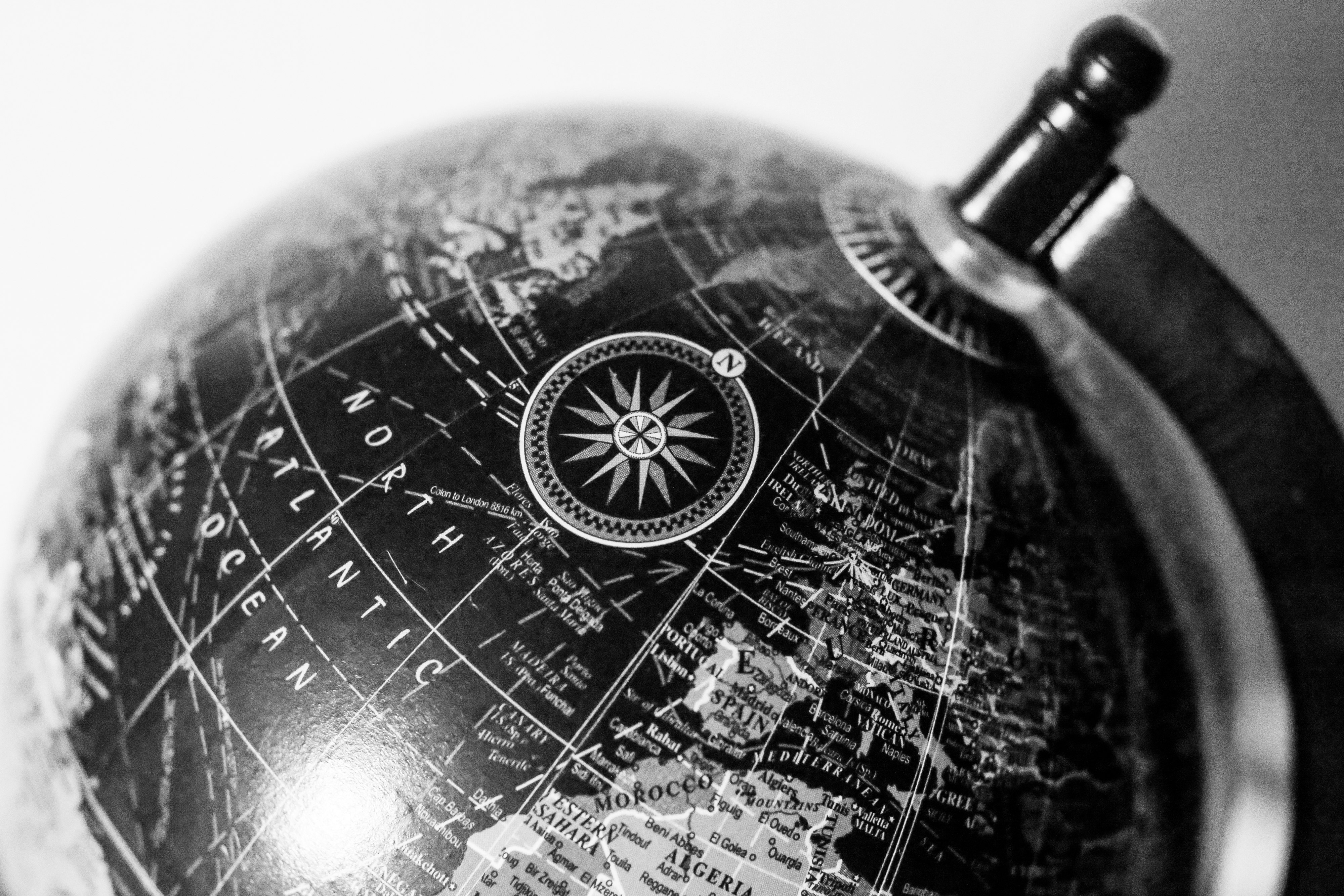 globe with compass and navigational map overlay