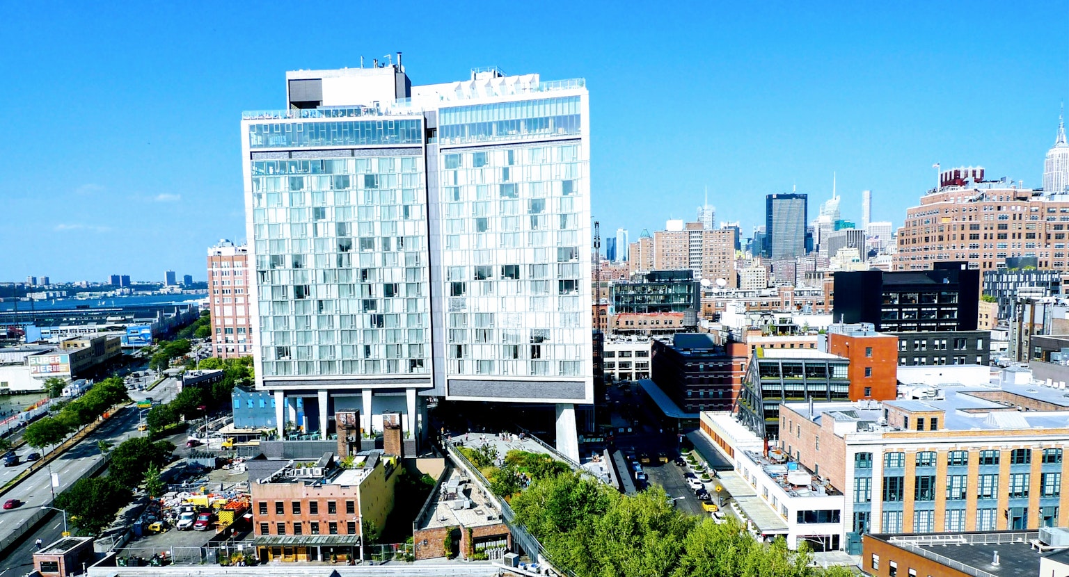 Modern glass building in an urban landscape under a clear blue sky