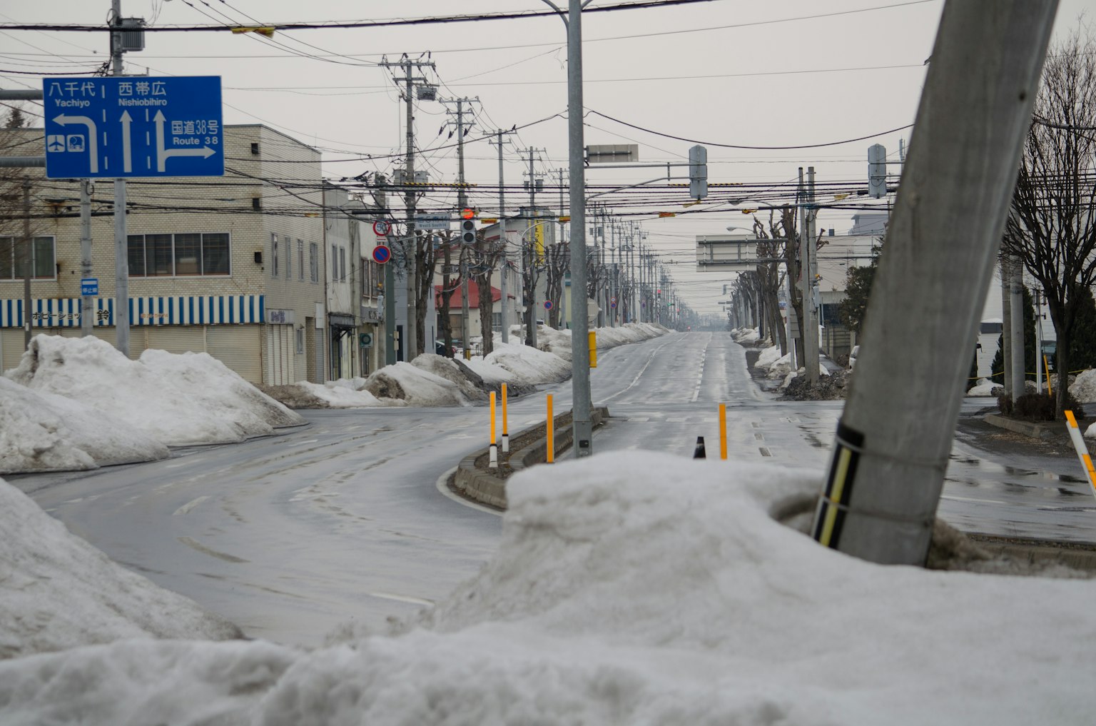 Winter scene with snow-covered road and traffic signs