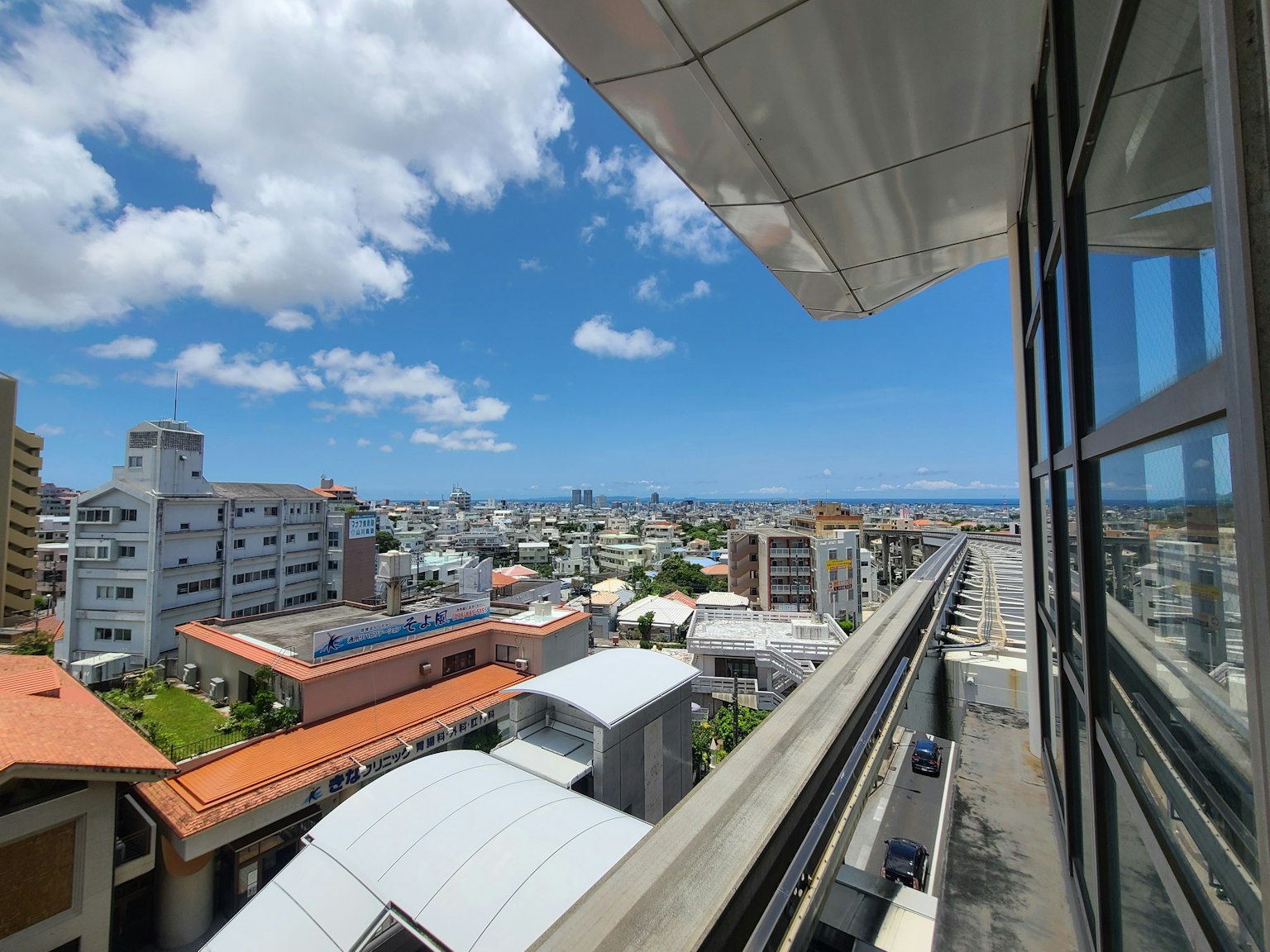 Cityscape view with blue sky and clouds from a rooftop