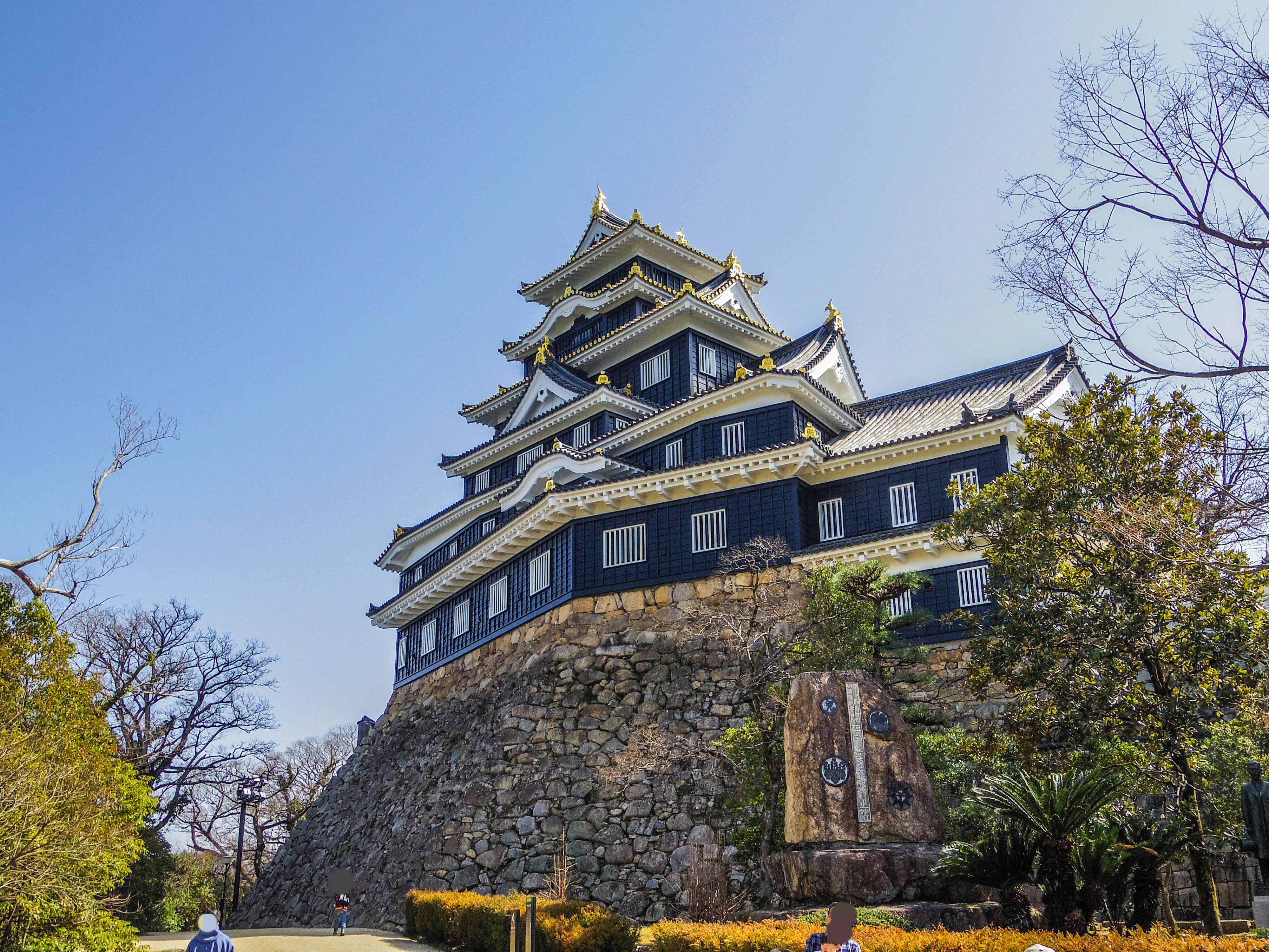 岡山城の天守閣と石垣、青空の下の城郭風景