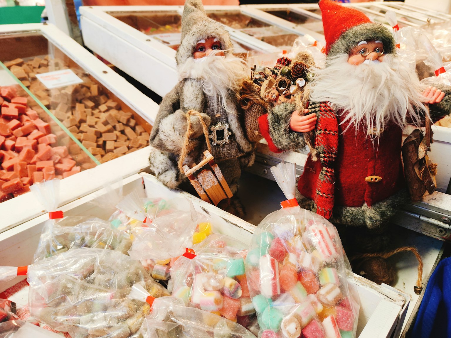 Christmas decorations featuring Santa Claus figurines and colorful bags of candy