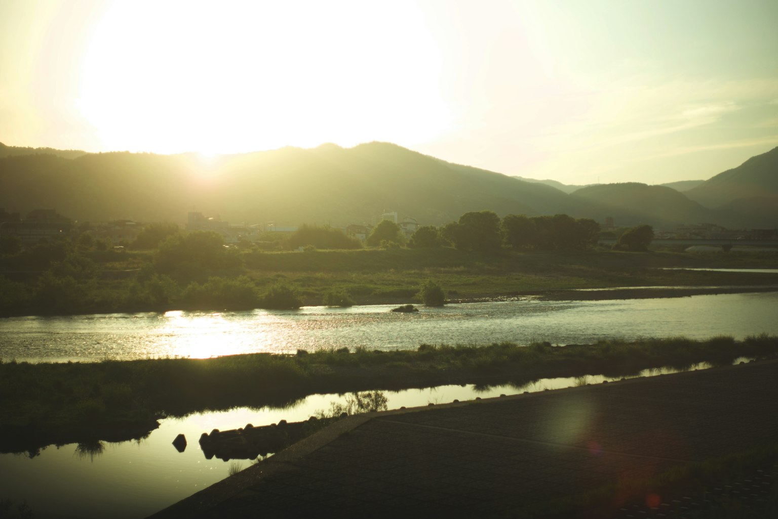 Sunset over a river and mountains