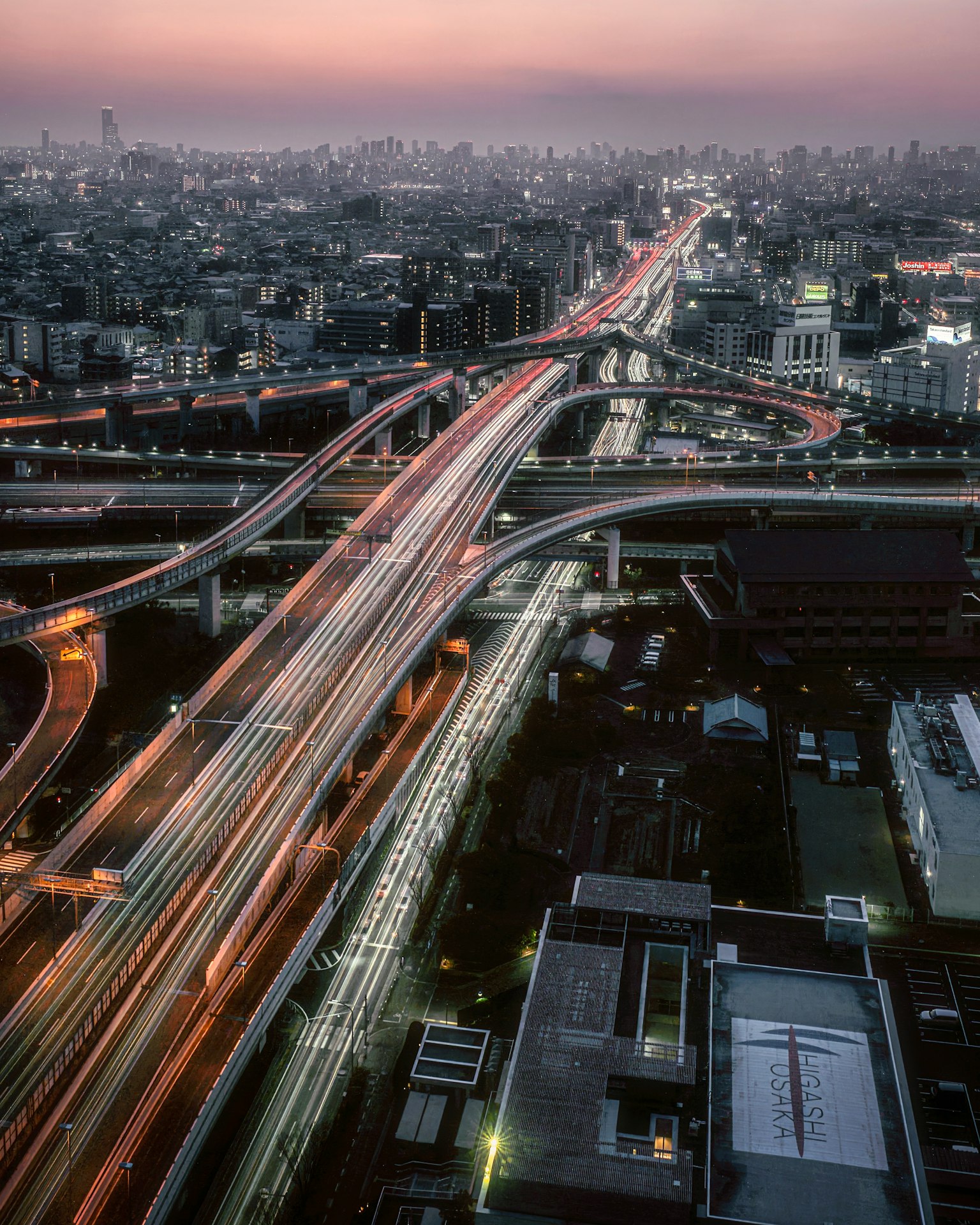 Aerial view of Tokyo at night featuring intersecting highways