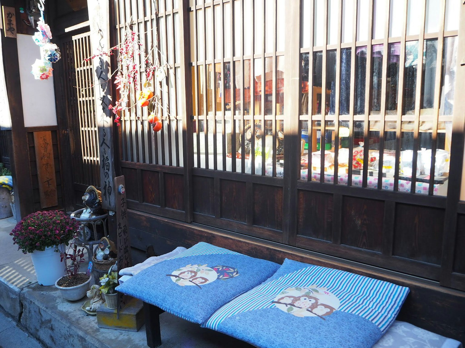 Traditional Japanese house exterior featuring blue cushions and wooden lattice