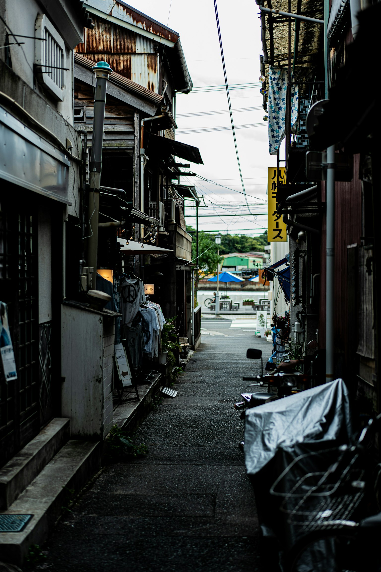 Narrow alley with old buildings and power lines