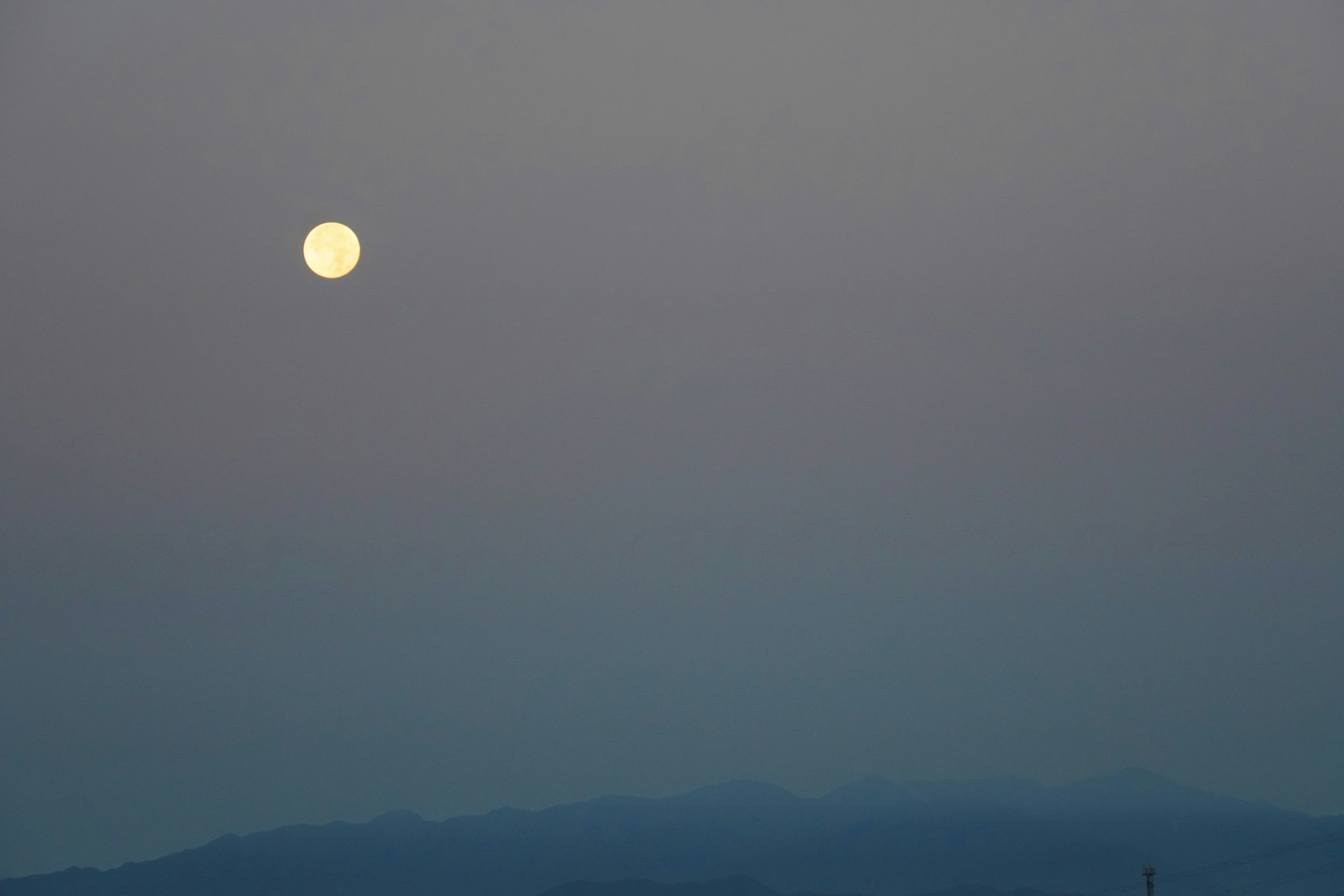 cloudy mountain range with a moonlike glow