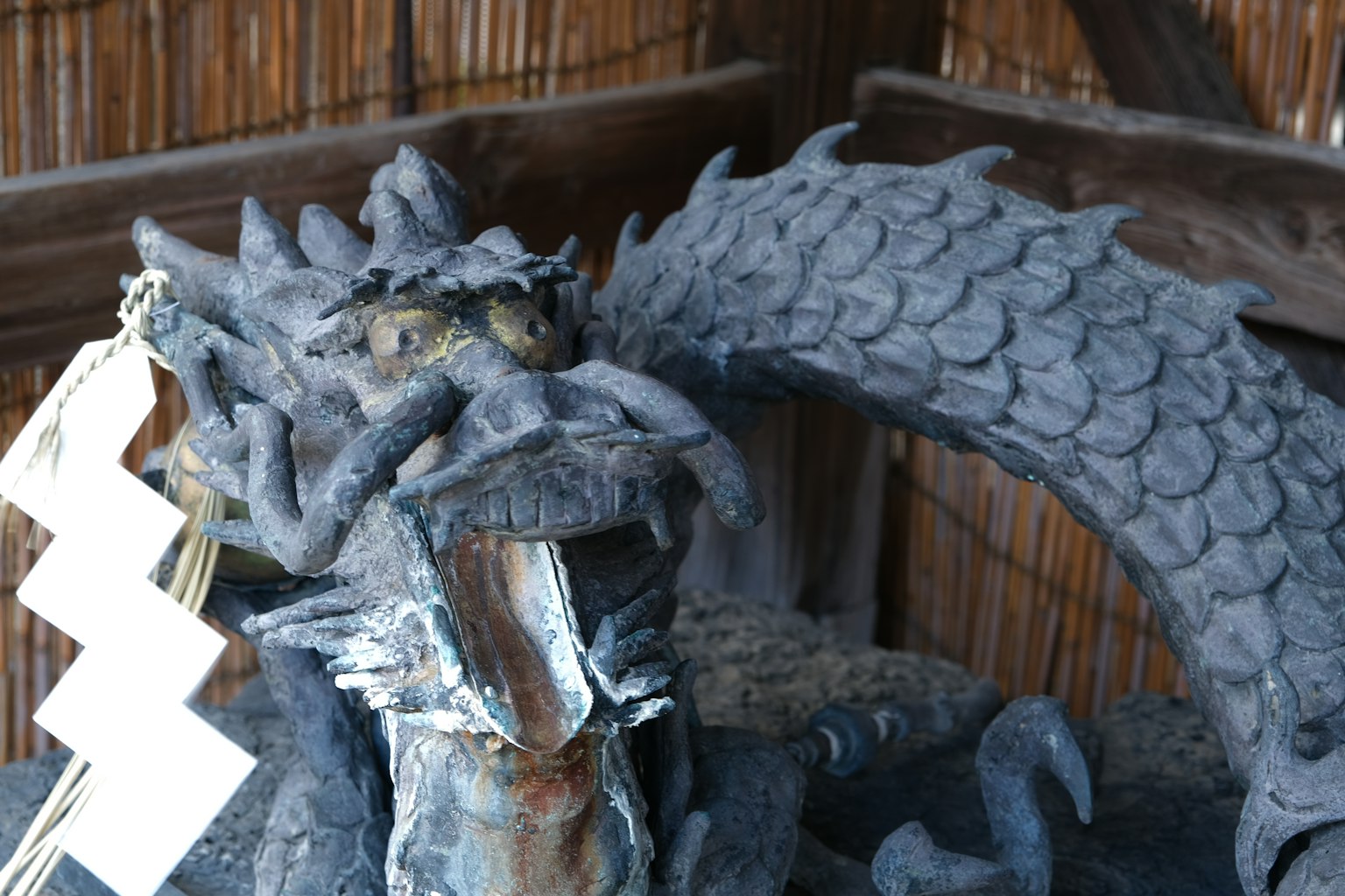 A detailed dragon sculpture featured in a shrine decoration