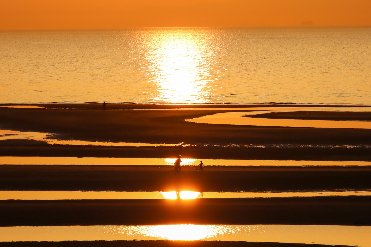 Sunset over the ocean with rippling reflections