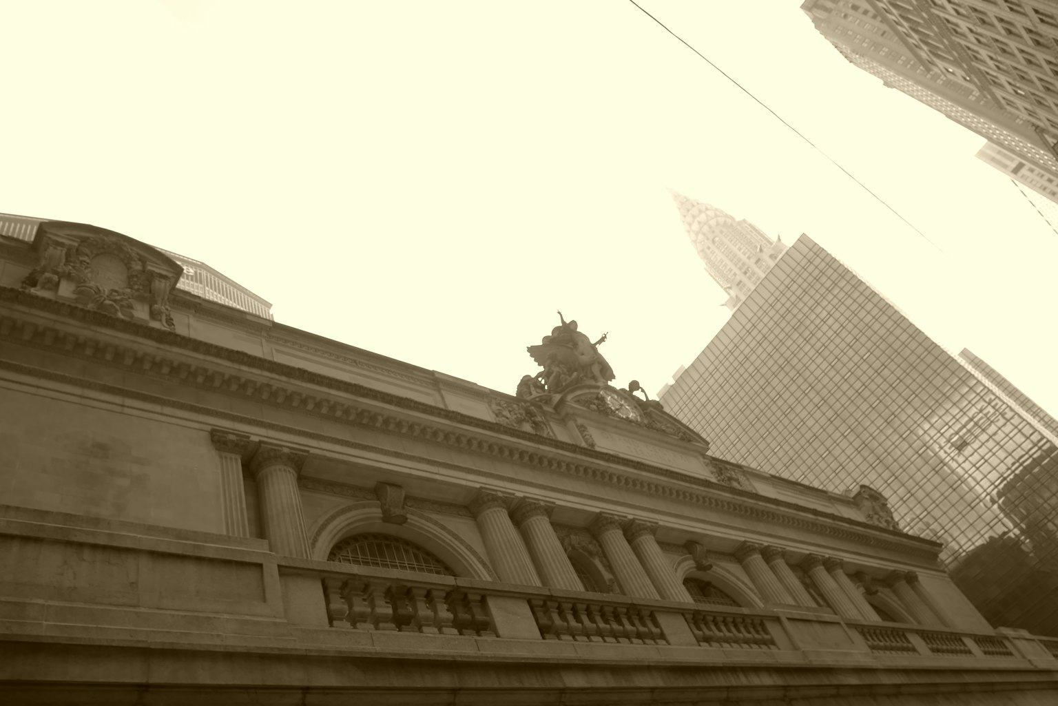 Sepia-toned exterior of New York Public Library with skyscrapers in background