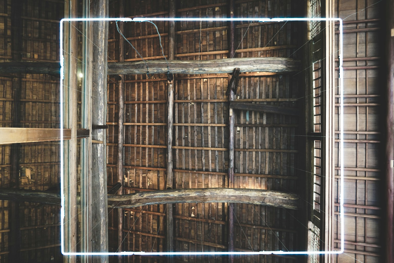 Image of an old wooden ceiling structure showcasing intricate wood details and natural color tones