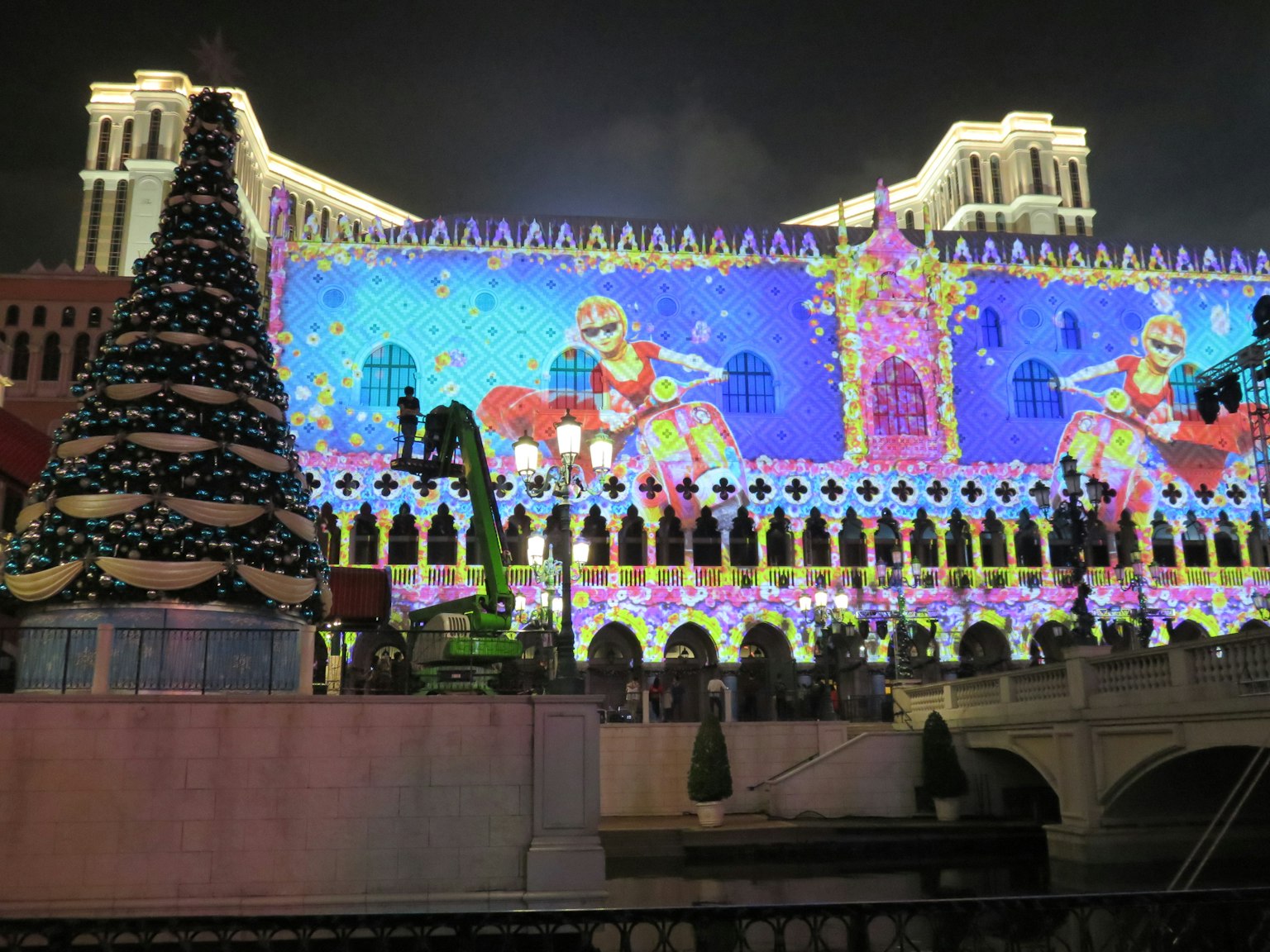 Christmas light display projected on the Venetian hotel's facade at night