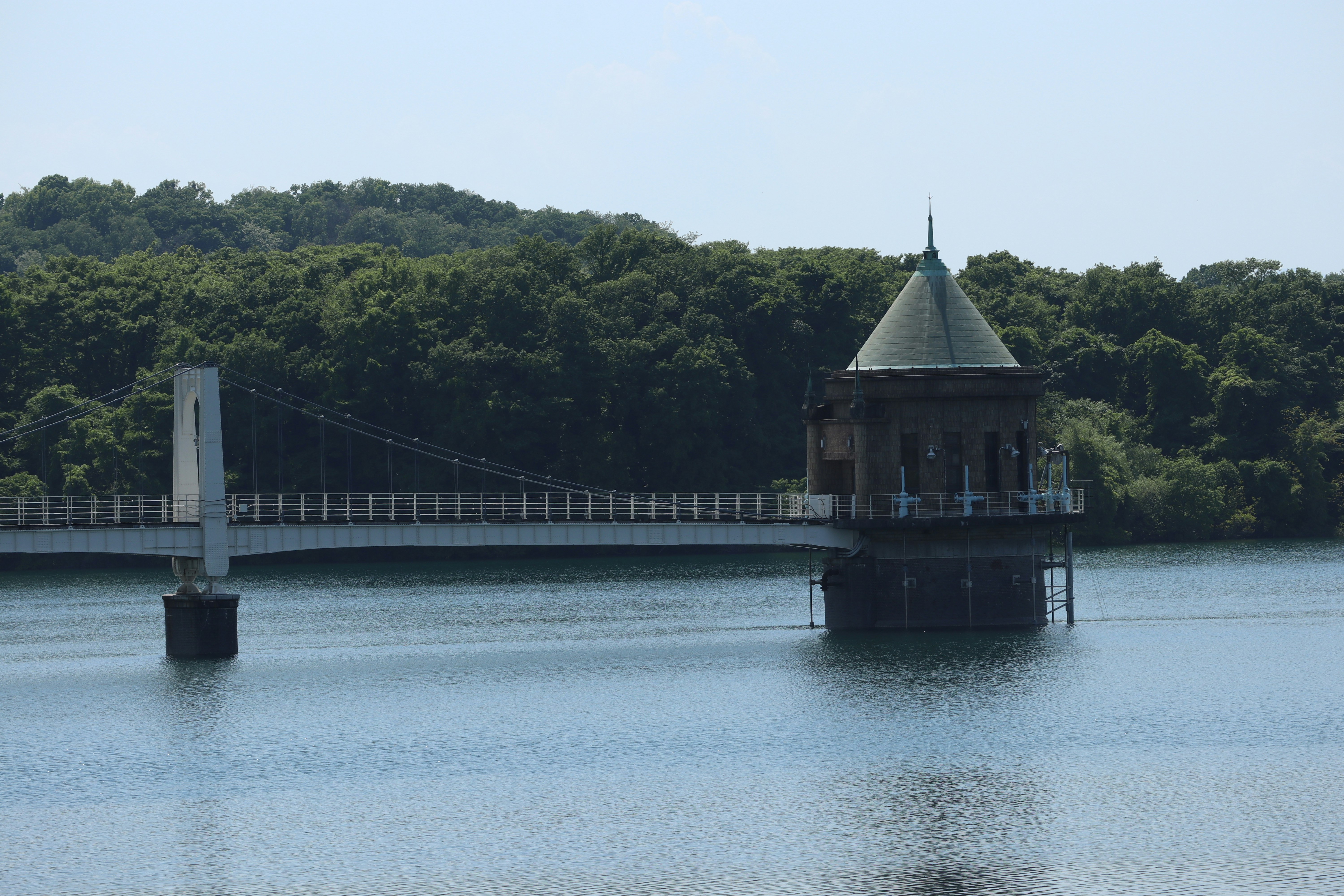 View of a tower on a lake with a bridge