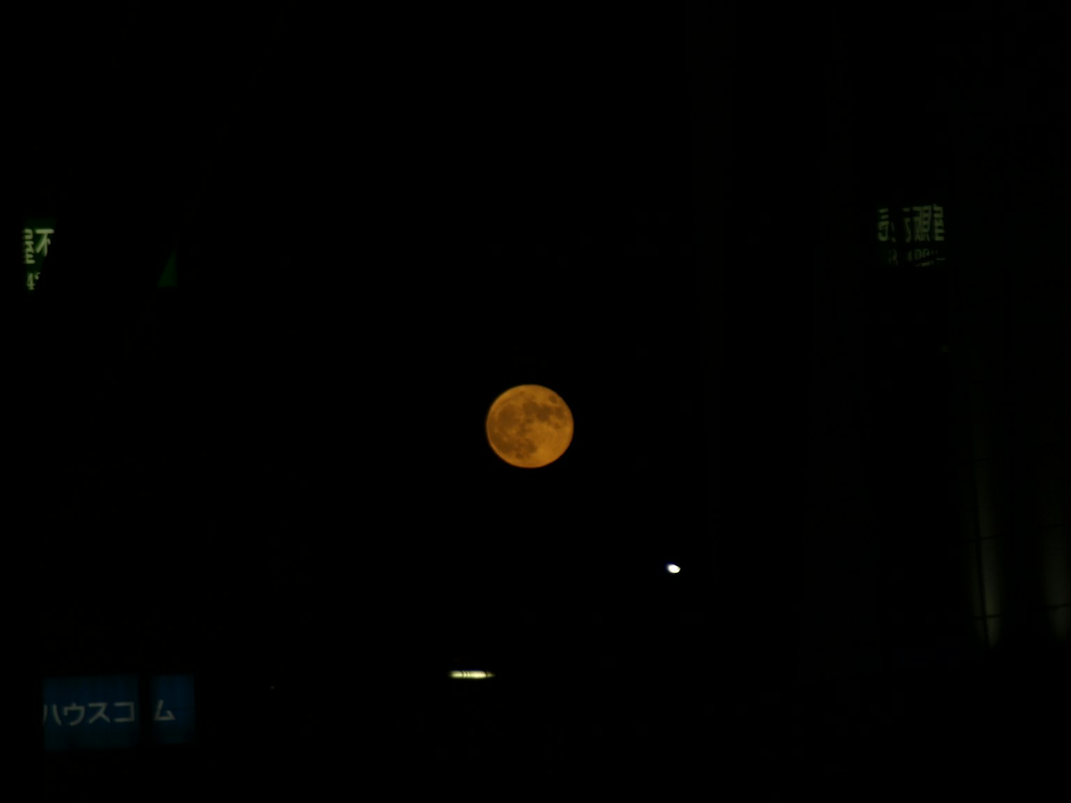 Bulan purnama oranye di latar belakang gelap
