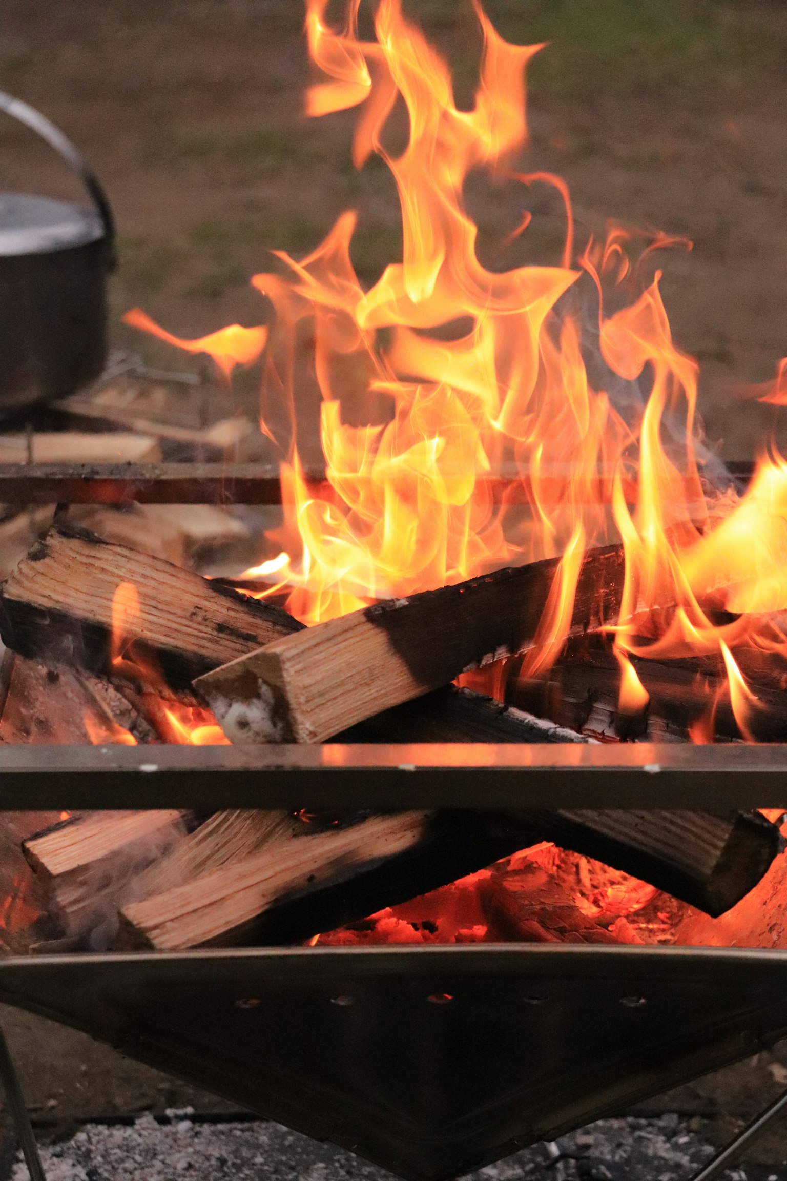 A campfire with vibrant flames and wooden logs