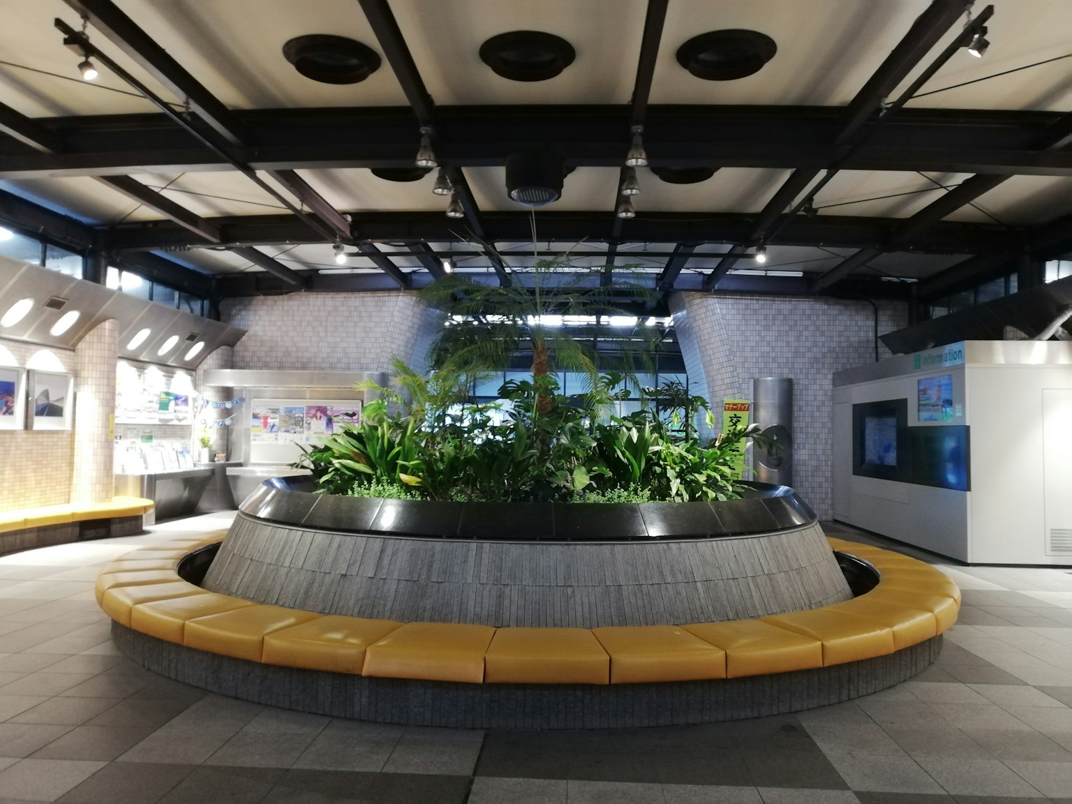 Spacious indoor area featuring a central planter with greenery