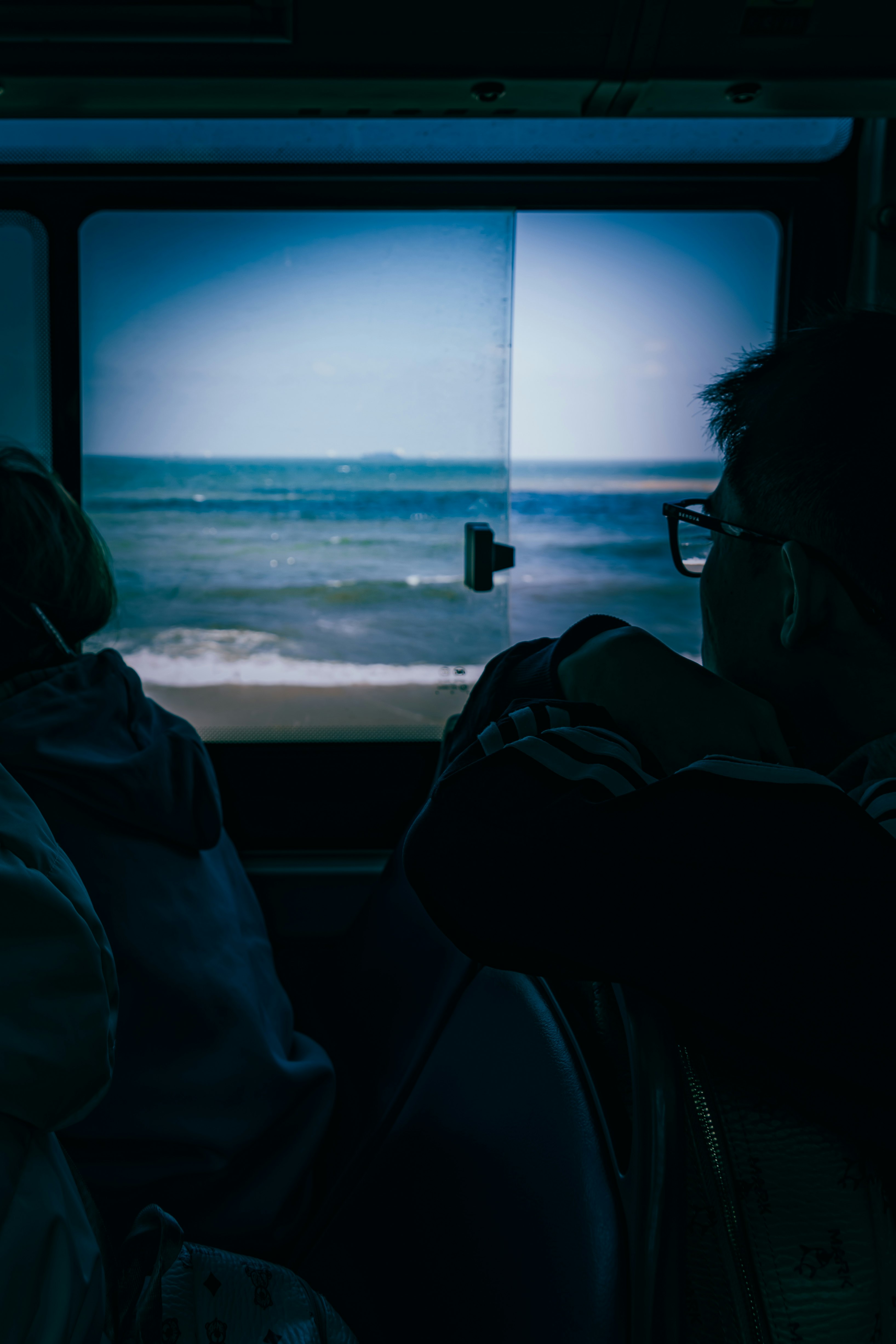 車窓から見える海辺の夕暮れ