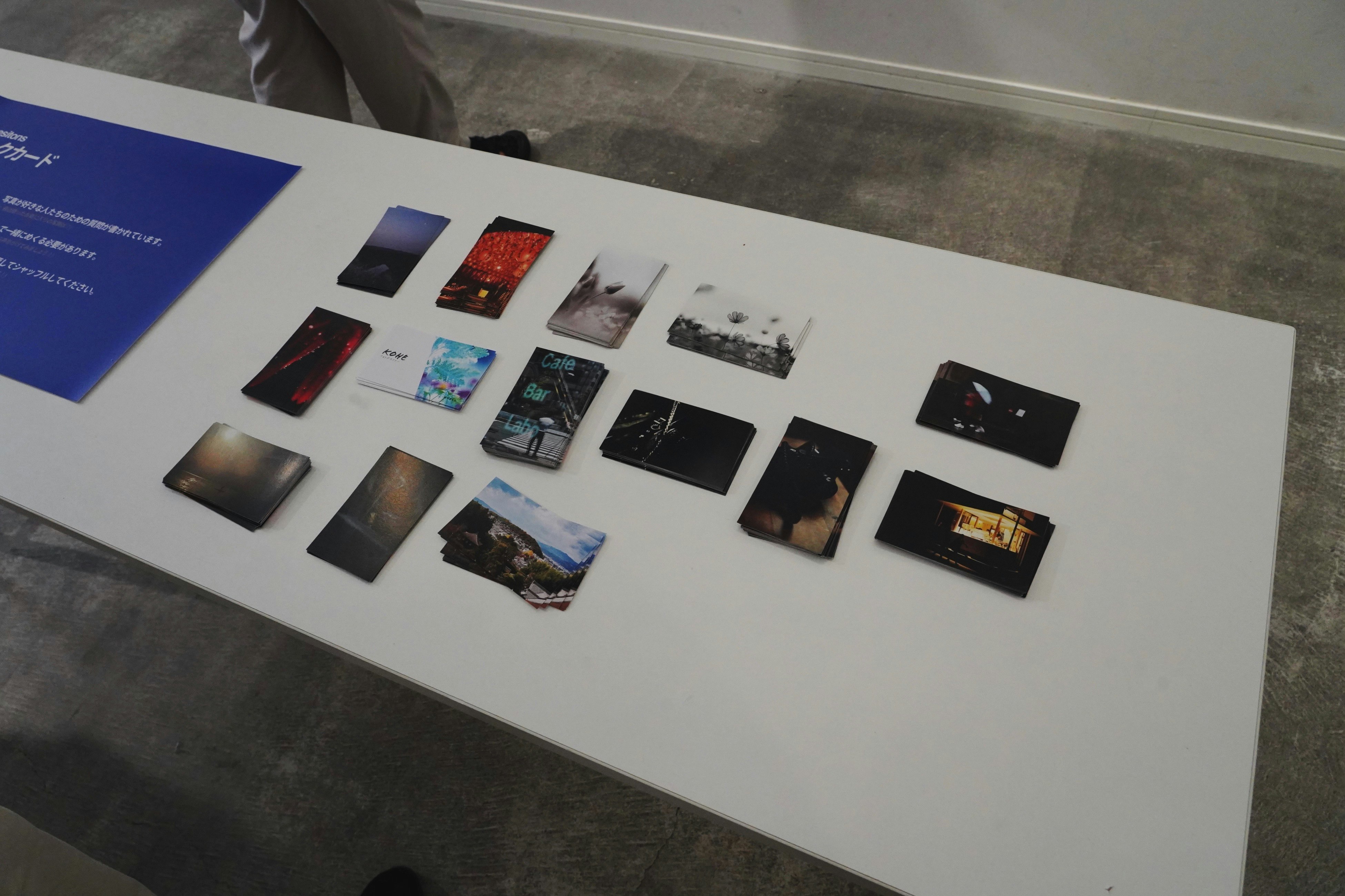 business-card sized poster artworks displayed on a table