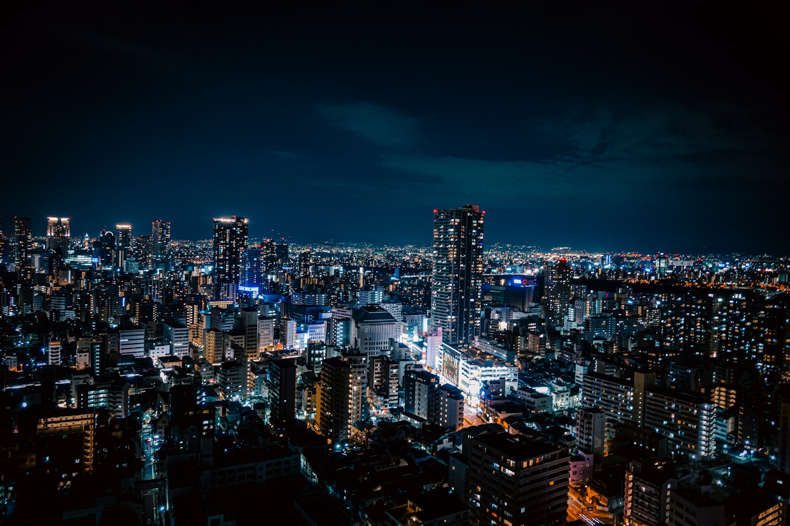 Nächtliche Aussicht auf eine Stadt mit beleuchteten Wolkenkratzern in Tokio
