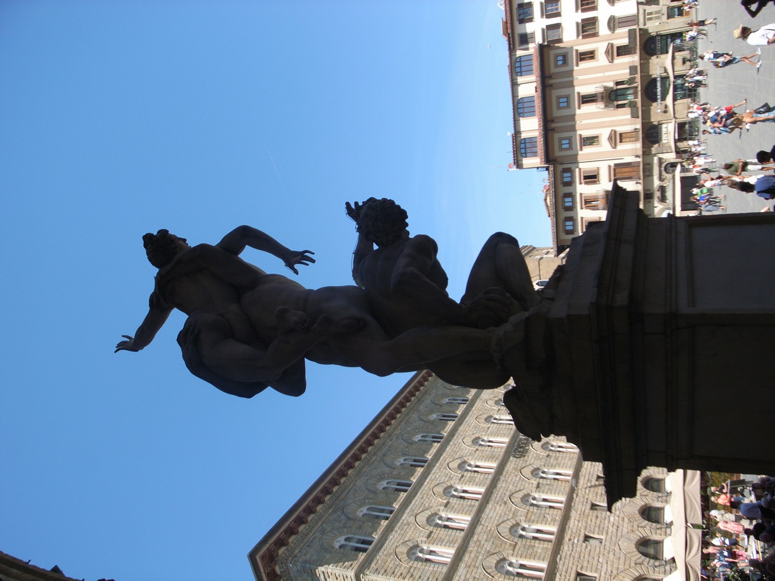 Silhouette of a statue in a Florence square against a blue sky detailed features of the sculpture