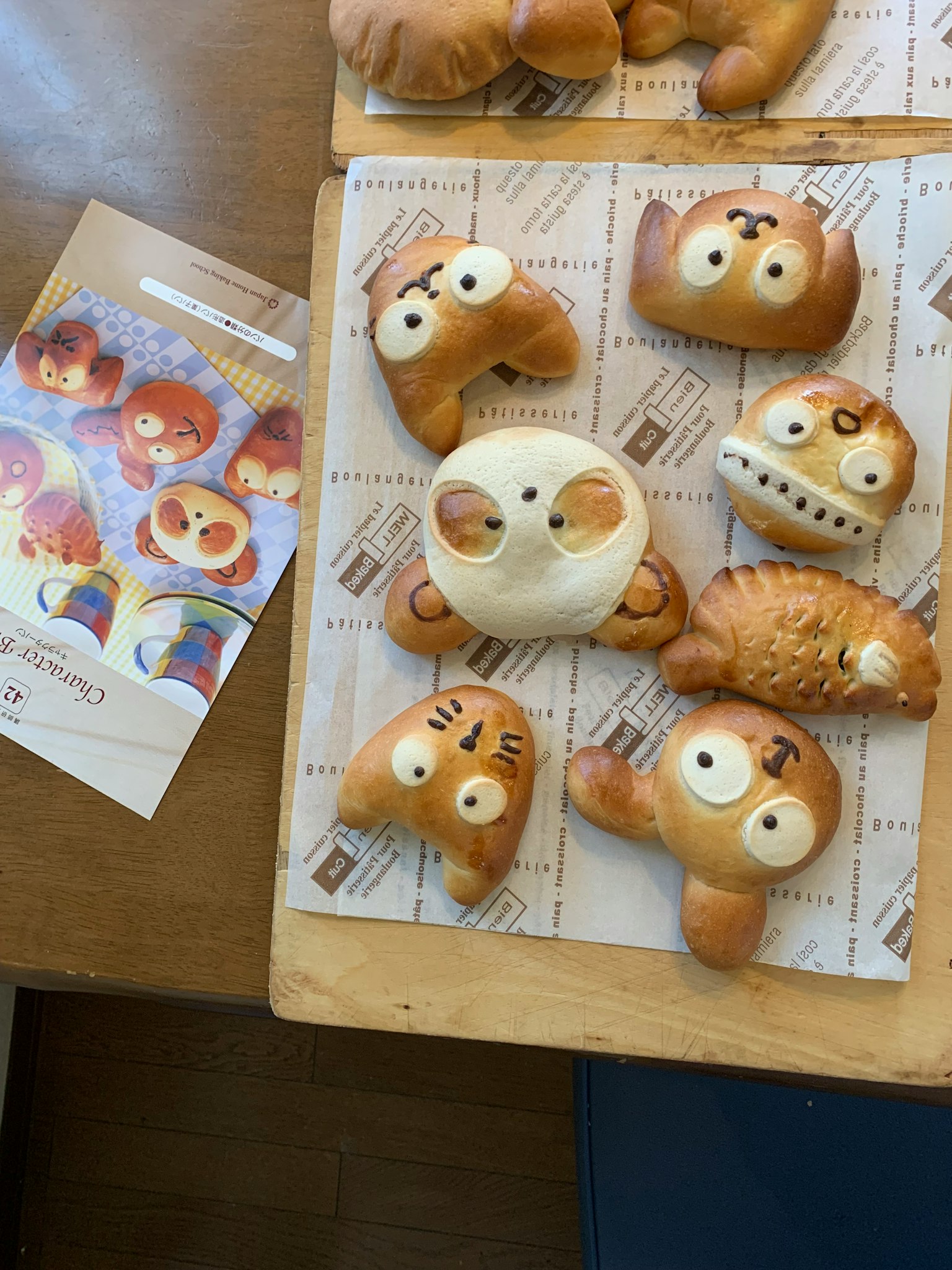 A variety of cute animal-shaped breads displayed on a wooden table