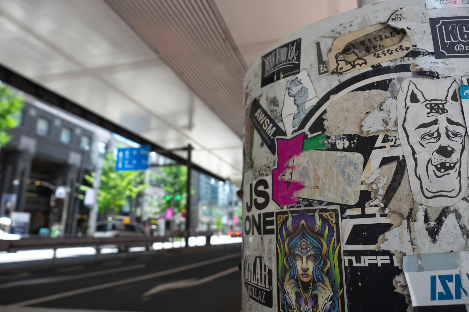 Poteau recouvert d'autocollants avec arrière-plan urbain