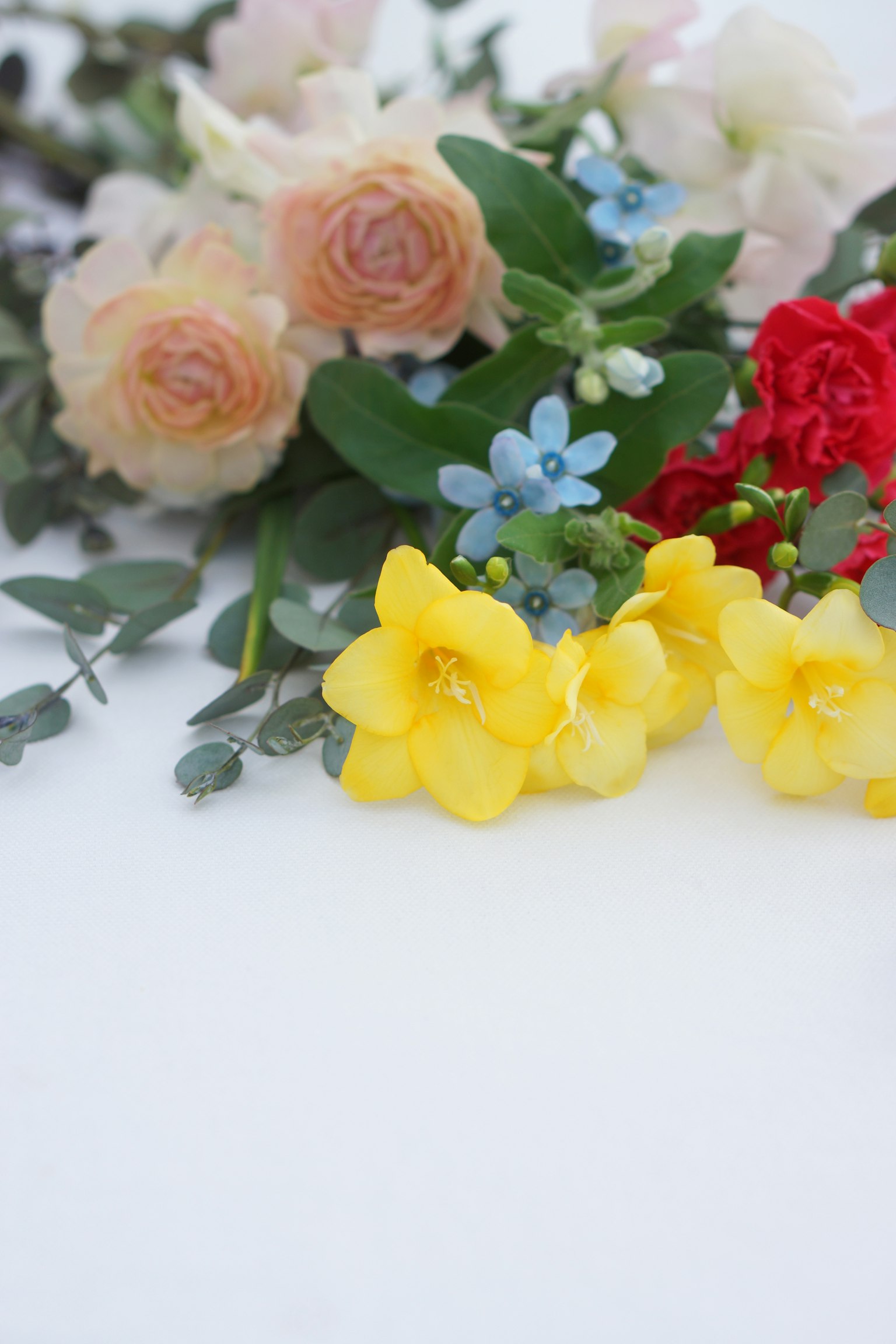 A beautiful arrangement of colorful flowers including yellow, red, and blue blooms