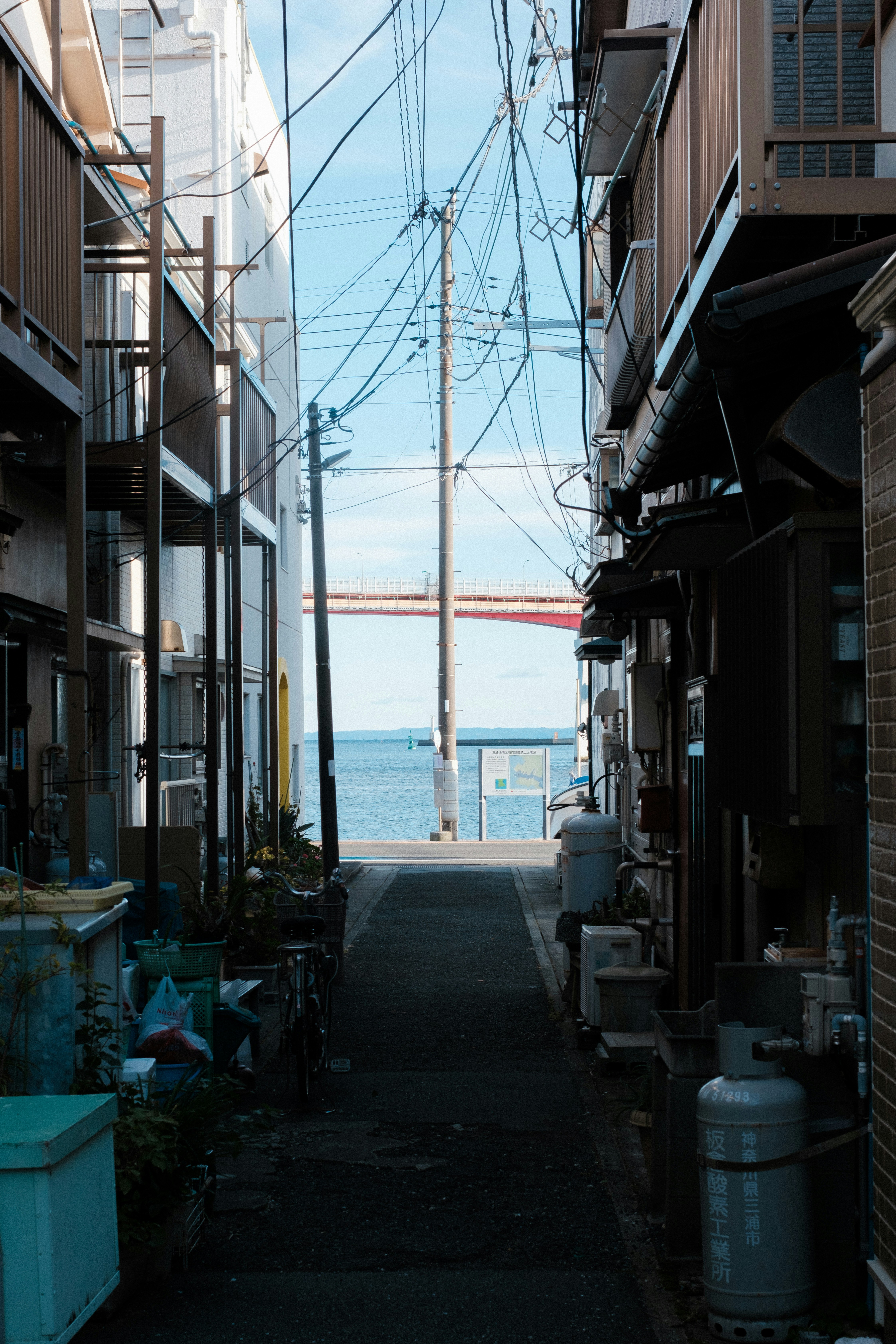 narrow alley with the sea visible in the distance