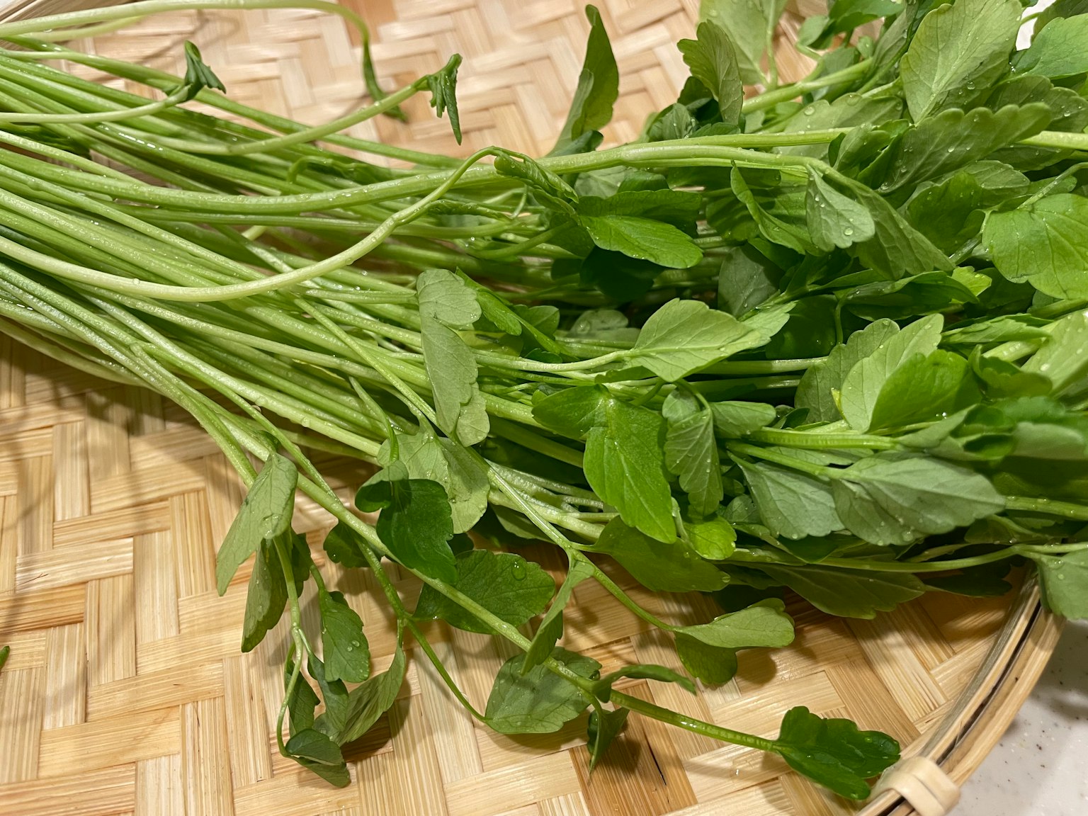 Fresh herbs placed on a bamboo basket