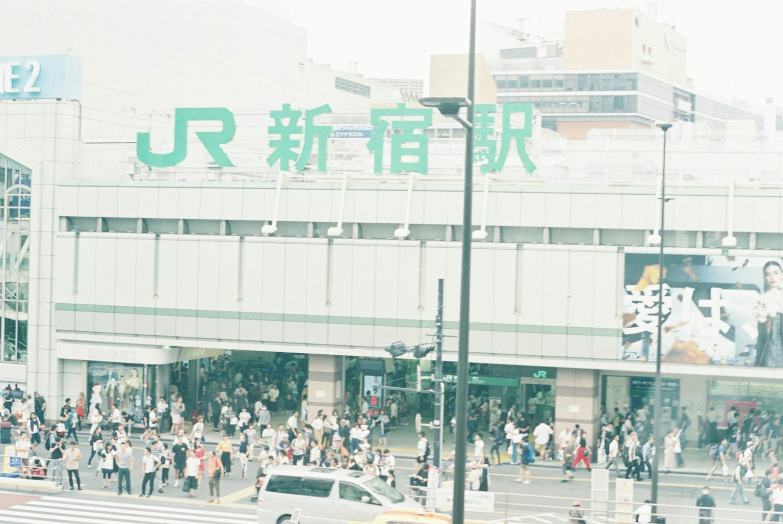 Exterior of Shinjuku Station with a large crowd