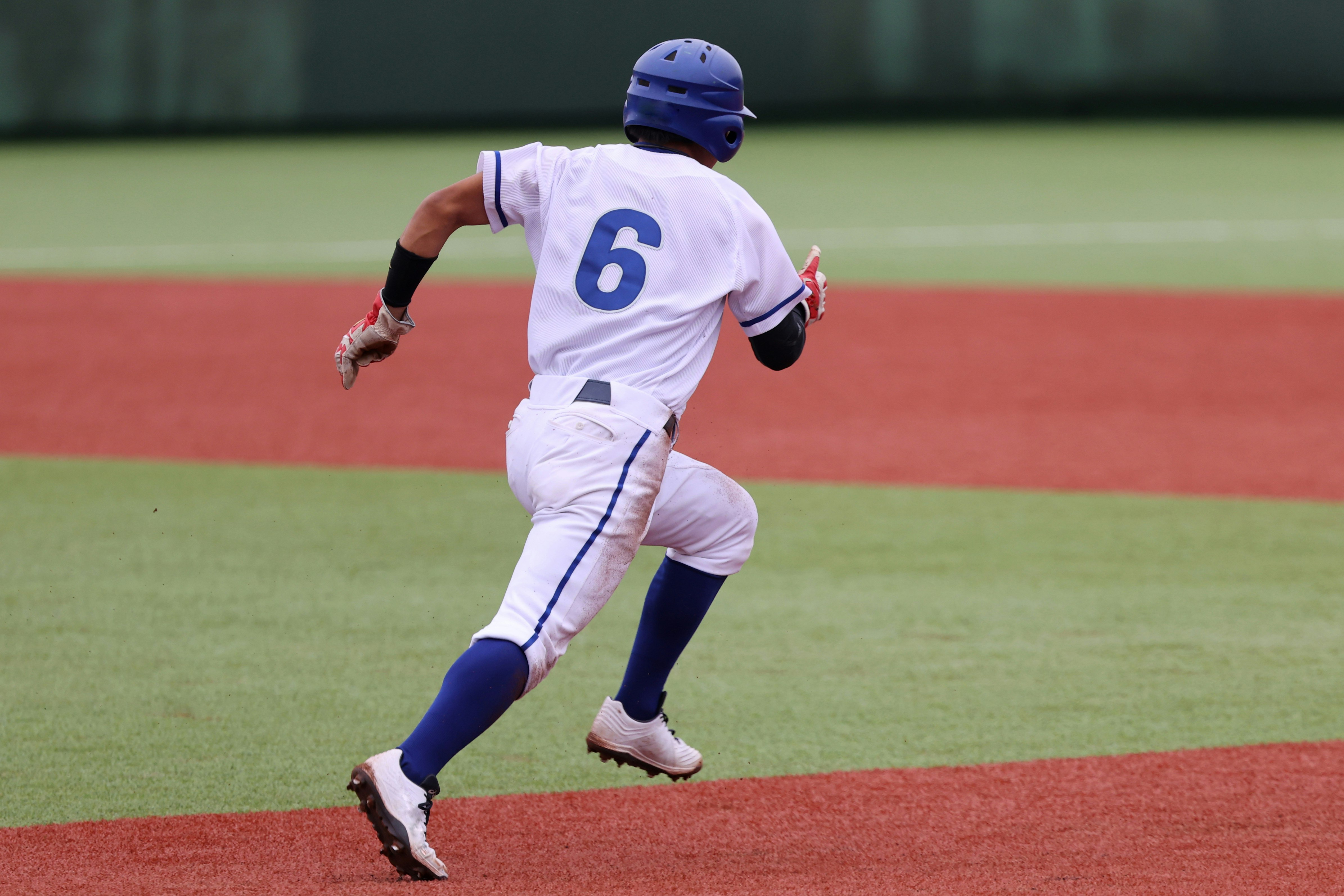 Baseball field infield defense with a player throwing the ball
